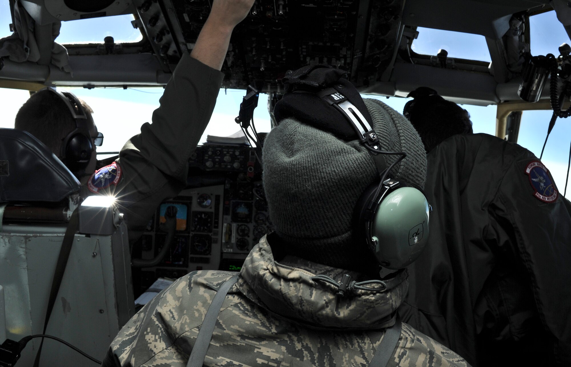 Airman First Class Jerod Cyrus, 92nd Comptroller Squadron, looks out a side window of the cockpit of a KC- 135 Stratotanker during an incentive refueling flight over Calif., Feb. 26, 2014.  The incentive flying programs are spread throughout the Air Force to entice good morale, a sense of purpose and recognition of a job well done. (U.S. Air Force Photo by Staff Sgt. Alexandre Montes)