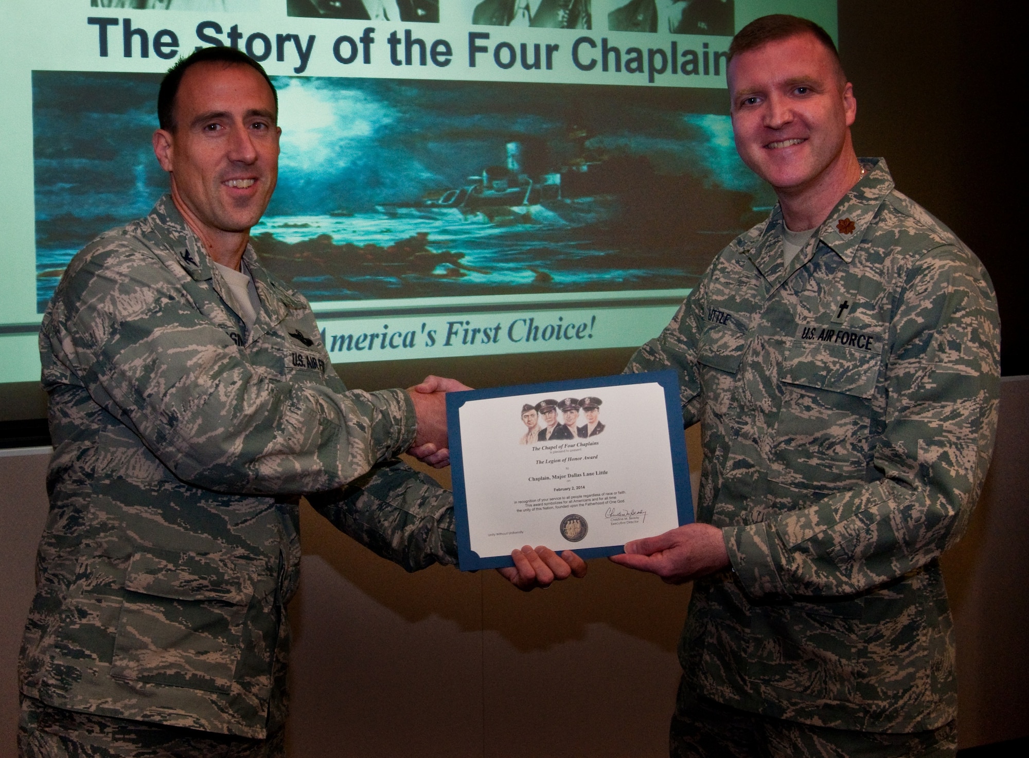 Col. Leonard Kosinski, 60th Air Mobility Wing vice commander, presents Maj. Dallas Little, 60th AMW chaplain, The Chapel of Four Chaplains’  Legion of Honor Award Feb. 12, at Travis Air Force Base, Calif. (U.S. Air Force photo/Senior Airman Charles Rivezzo)