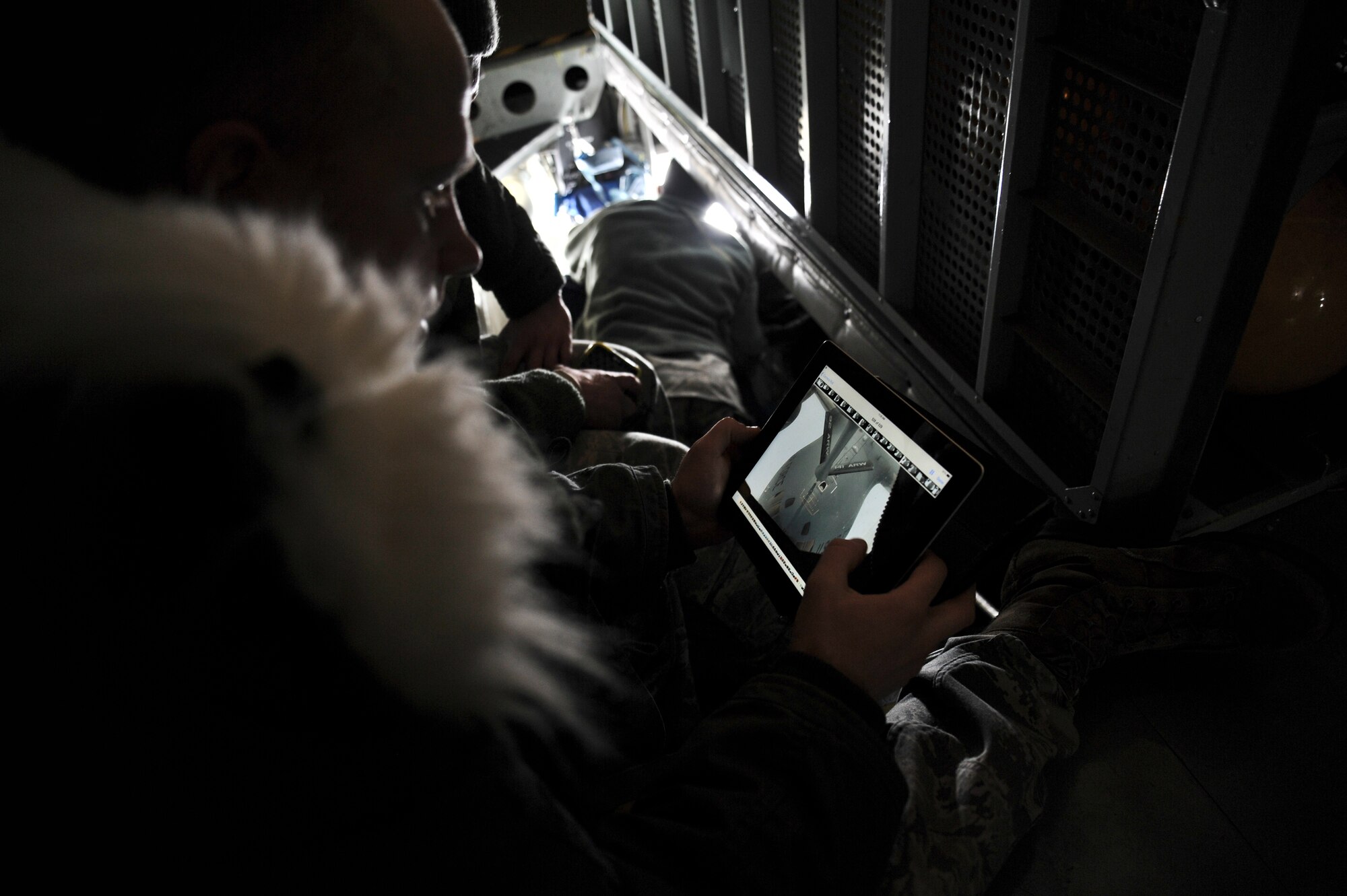 Tech. Sgt. Brad Barkhauer, 92nd Air Refueling Wing chapel services, watches a video he recorded of a C-17 being refueling by a 92nd Air Refueling Wing KC- 135 Stratotanker during an incentive refueling flight over Calif., Feb. 26, 2014.  The incentive flying programs are spread throughout the Air Force to entice good morale, a sense of purpose and recognition of a job well done. (U.S. Air Force Photo by Staff Sgt. Alexandre Montes)