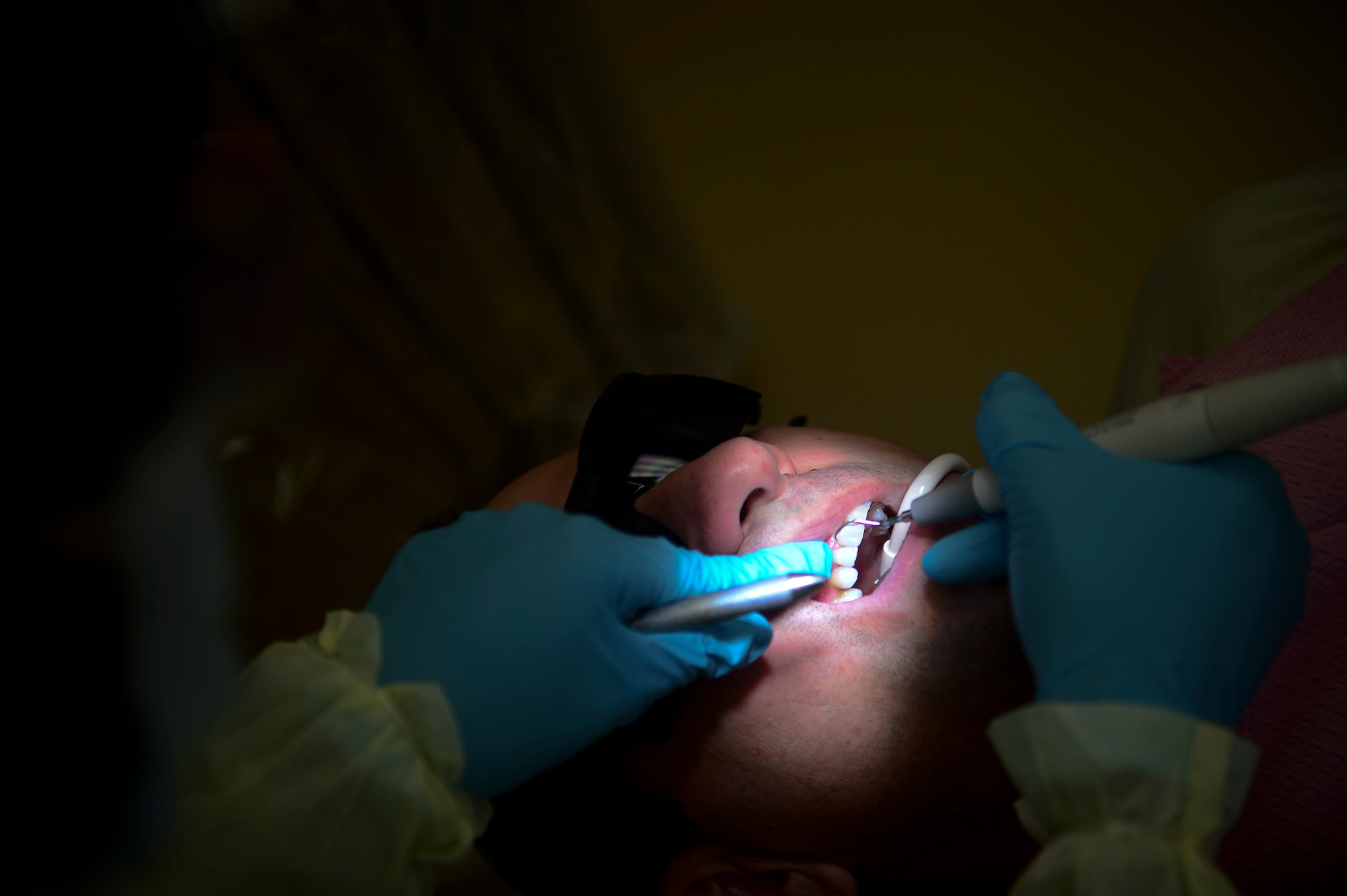 Lt. Col. Thomas Anderson, 310th Airlift Squadron deputy director of staff, has his teeth cleaned Feb. 27, 2014, at MacDill Air Force Base, Fla. The 6th Dental Squadron provides care to all active duty, family members, retired and Department of Defense personnel on base. (U.S. Air Force photo by Senior Airman Jenay Randolph/Released)