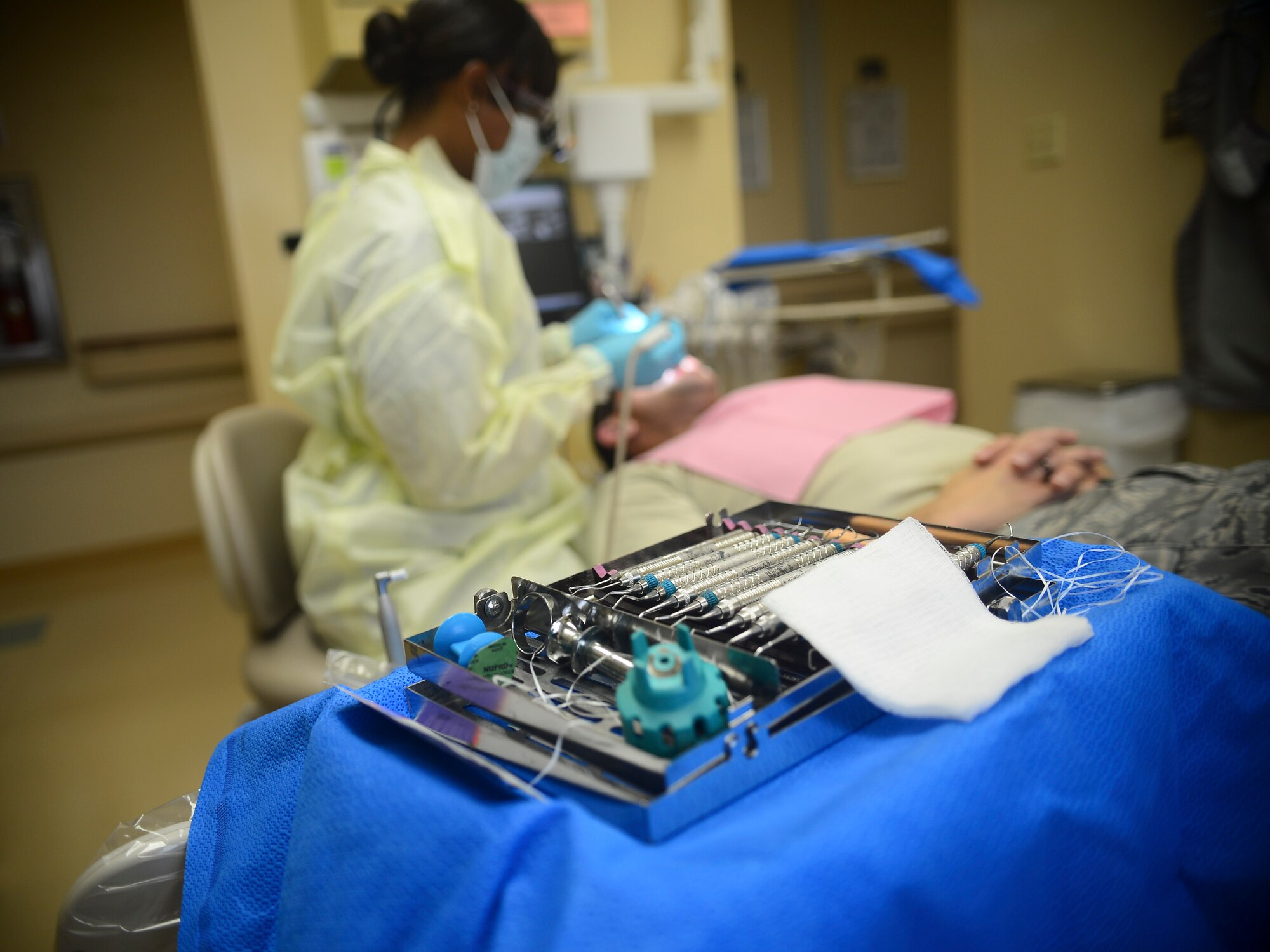 Master Sgt. Adilah Everett-Long, 6th Dental Squadron oral dental hygienist, performs teeth cleaning Feb. 27, 2014, at MacDill Air Force Base, Fla. Dental hygienists provide preventive services to promote and maintain good oral health. (U.S. Air Force photo by Senior Airman Jenay Randolph/Released)