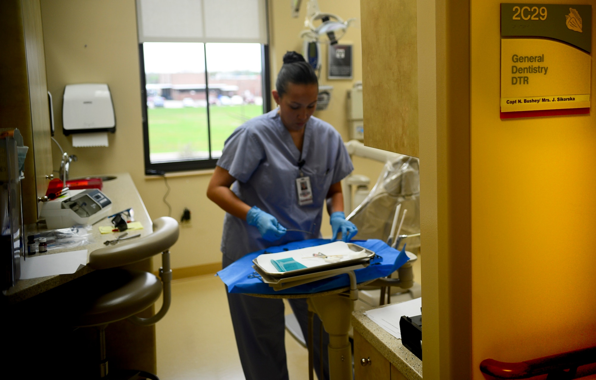 Santana Polite, American Red Cross volunteer, prepares tools used for an oral examination Feb. 27, 2014, at MacDill Air Force Base, Fla. The 6th Dental Squadron is teaming up with the American Red Cross to offer a program called “Red Cross Dental Assistant Training Program” beginning March 3, 2014.(U.S. Air Force photo by Senior Airman Jenay Randolph/Released)