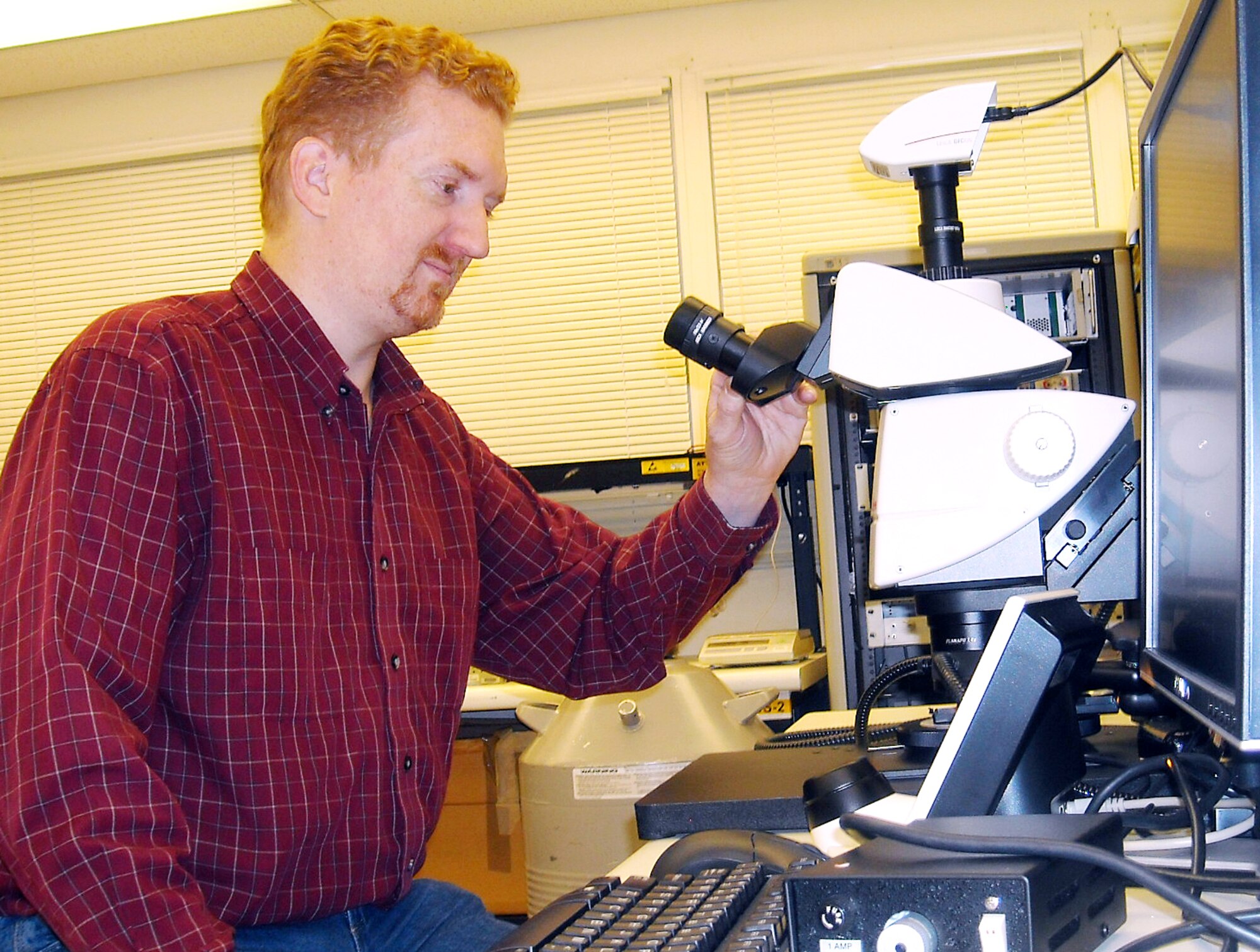 Robert Bird, electronics engineer at the Electronics Analysis Laboratory, prepares to examine a defective piece of equipment. The lab investigates electrical parts failures that could lead to delay in production. (U.S. Air Force photo by Brian Shreve)