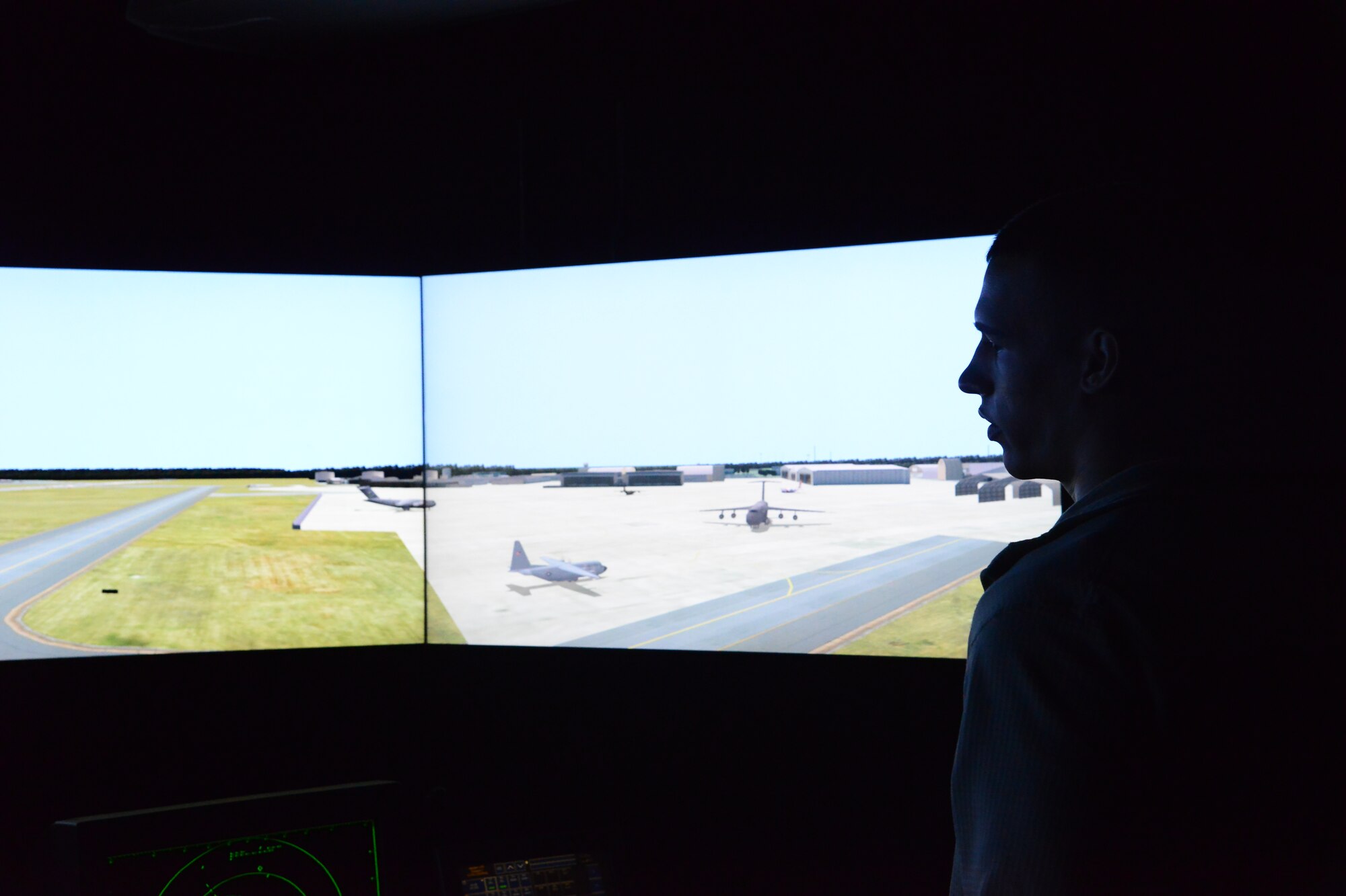 Airman 1st Class Mitchel Hooper, an Air Traffic Control Tower trainee, looks at a realistic view of the Robins airfield from the tower’s simulation room. Hooper is currently working to receive his control tower operator’s certification. (U.S. Air Force photo by Ray Crayton)