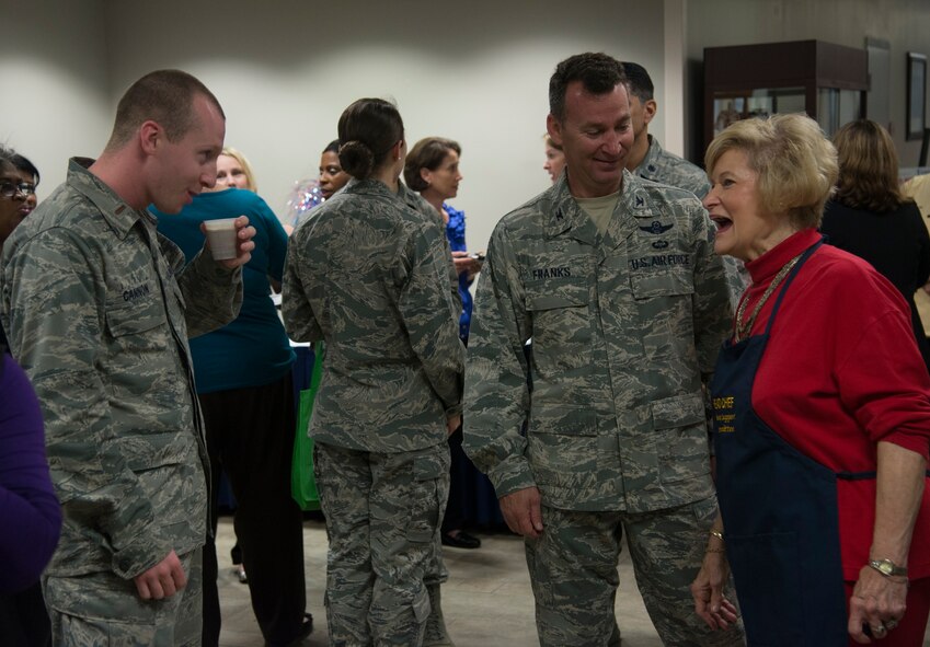 Dr. Lucy Greene tells U.S. Air Force Col. Chad Franks, 23d Wing commander, and 2nd Lt. Jacob Cannon, 23d Force Support Squadron food services officer, a joke at the Lucy’s Corner Café ribbon-cutting ceremony at Moody Air Force Base, Ga., Feb. 26, 2014. Dr. Lucy and Parker Greene help the Moody community through the Moody Support Committee. Cannon was responsible for organizing and planning the ceremony for the café. (U.S. Air Force photo by Airman Dillian Bamman/Released)
