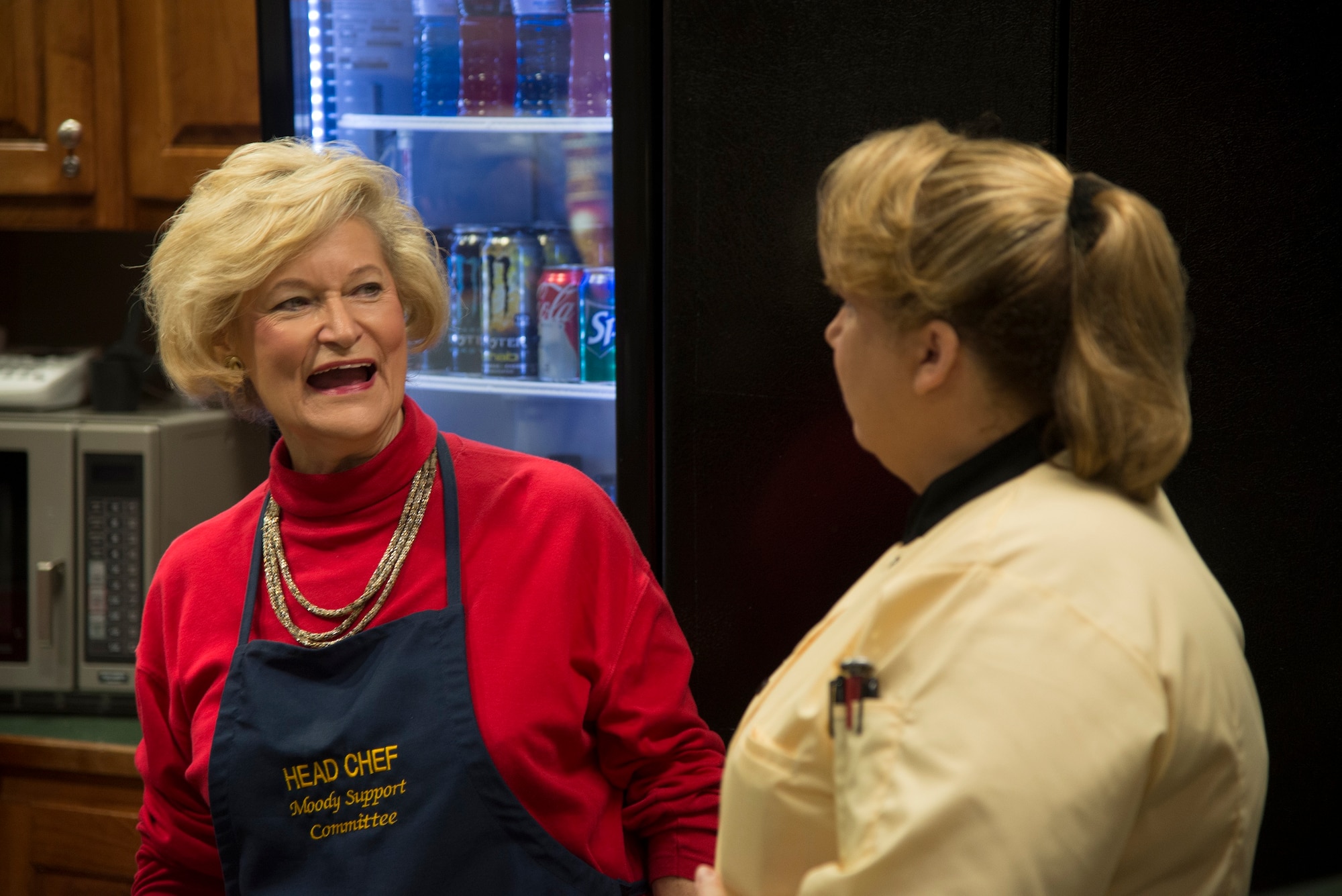 Carol Miller, Lucy’s Corner Café chef, serves coffee samples with Dr. Lucy Greene during a ribbon-cutting ceremony at Moody Air Force Base, Ga., Feb. 26, 2014. The café was built to give a morale boost to Moody Airmen, their families and retirees. (U.S. Air Force photo by Airman Dillian Bamman/Released)
