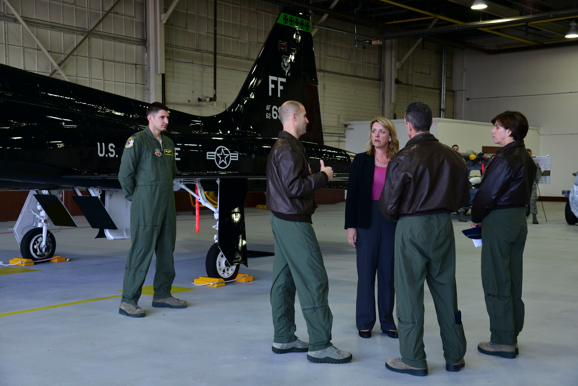 Secretary of the Air Force Deborah Lee James is met by U.S. Air Force Col. Matthew Venzke, 1st Maintenance Group commander, and Col. Edward Corcoran, 1st Operations Group commander, at the 1st Fighter Wing hangar at Langley Air Force Base, Va., Feb. 27, 2014. At the hangar, James was briefed about the F-22 Raptor’s mission overview and proficiency. (U.S. Air Force photo by Senior Airman Aubrey White/Released) 