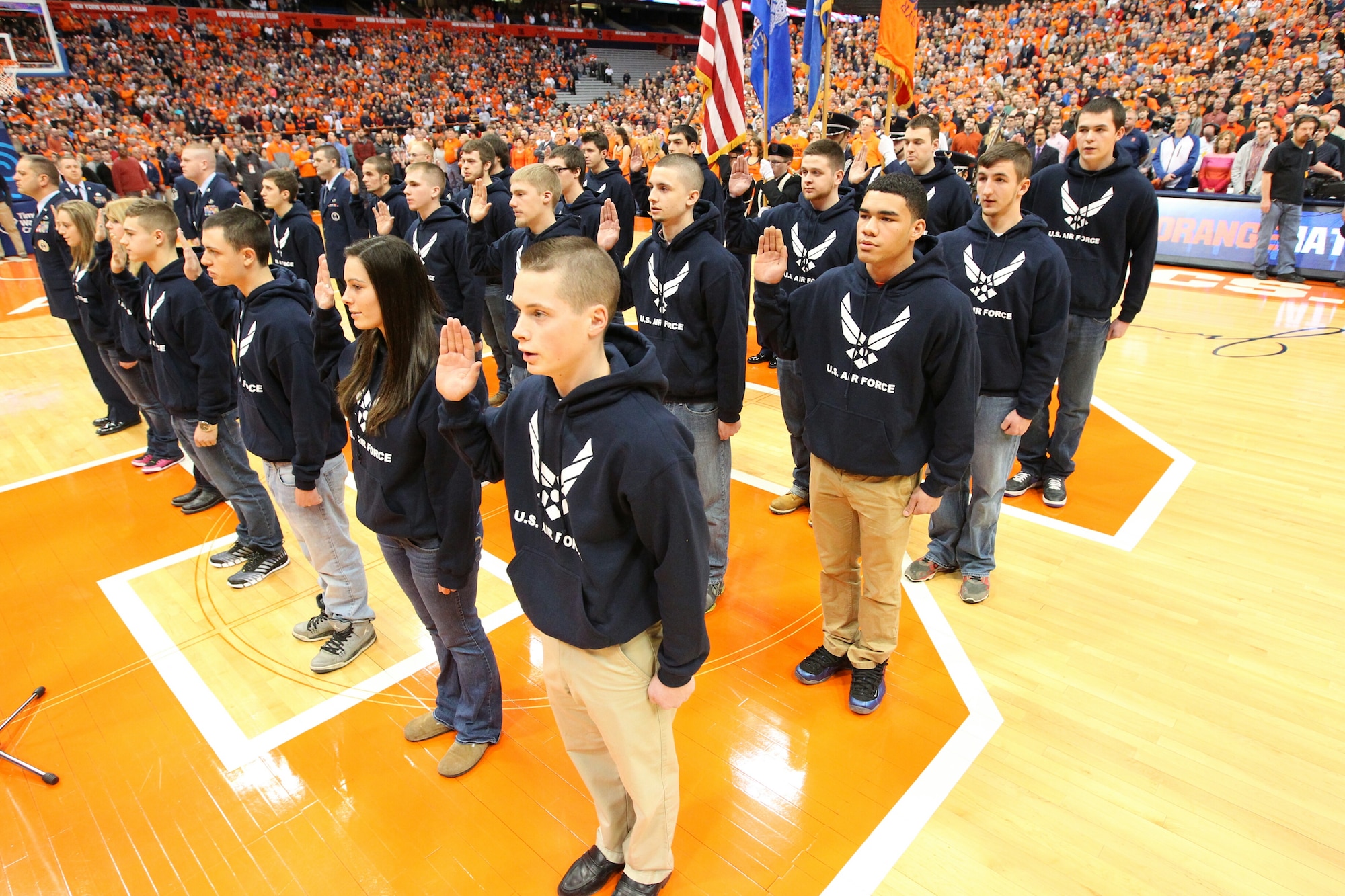 Delayed Entry Program members take the oath of enlistment at the Syracuse versus Pittsburgh college basketball game Jan. 18 in front of 30,046 basketball fans in Syracuse, N.Y. The oath of enlistment was administered by Lt. Col. John Hutcheson, 313th Recruiting Squadron commander (not pictured). The DEP members received a standing ovation from the crowd. (Courtesy photo)