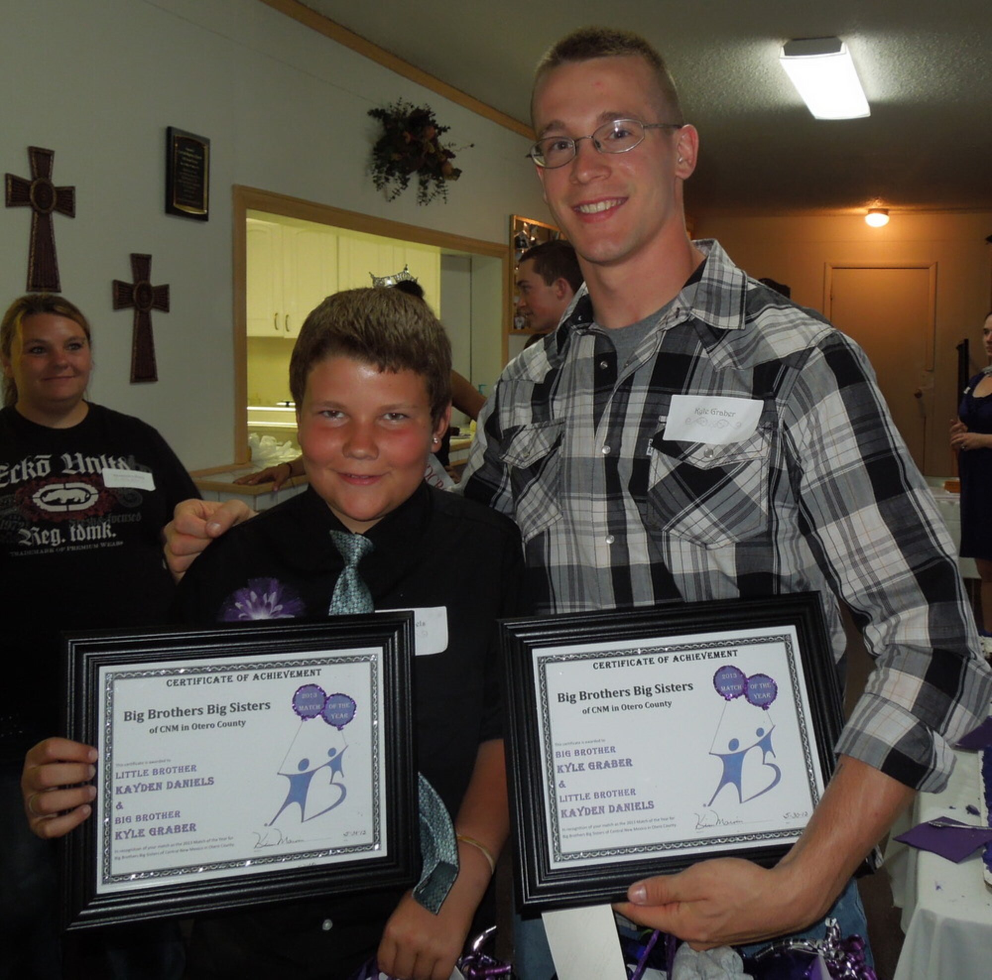 Senior Airman Kyle Graber, 49th Materiel Maintenance Group deployment training journeyman, and his little brother, receive the Big Brothers Big Sisters of Otero County Match of the Year award in Alamogordo, N.M.  Holloman Air Force Base hosts 36 active matches within the BBBS community. (Courtesy photo)