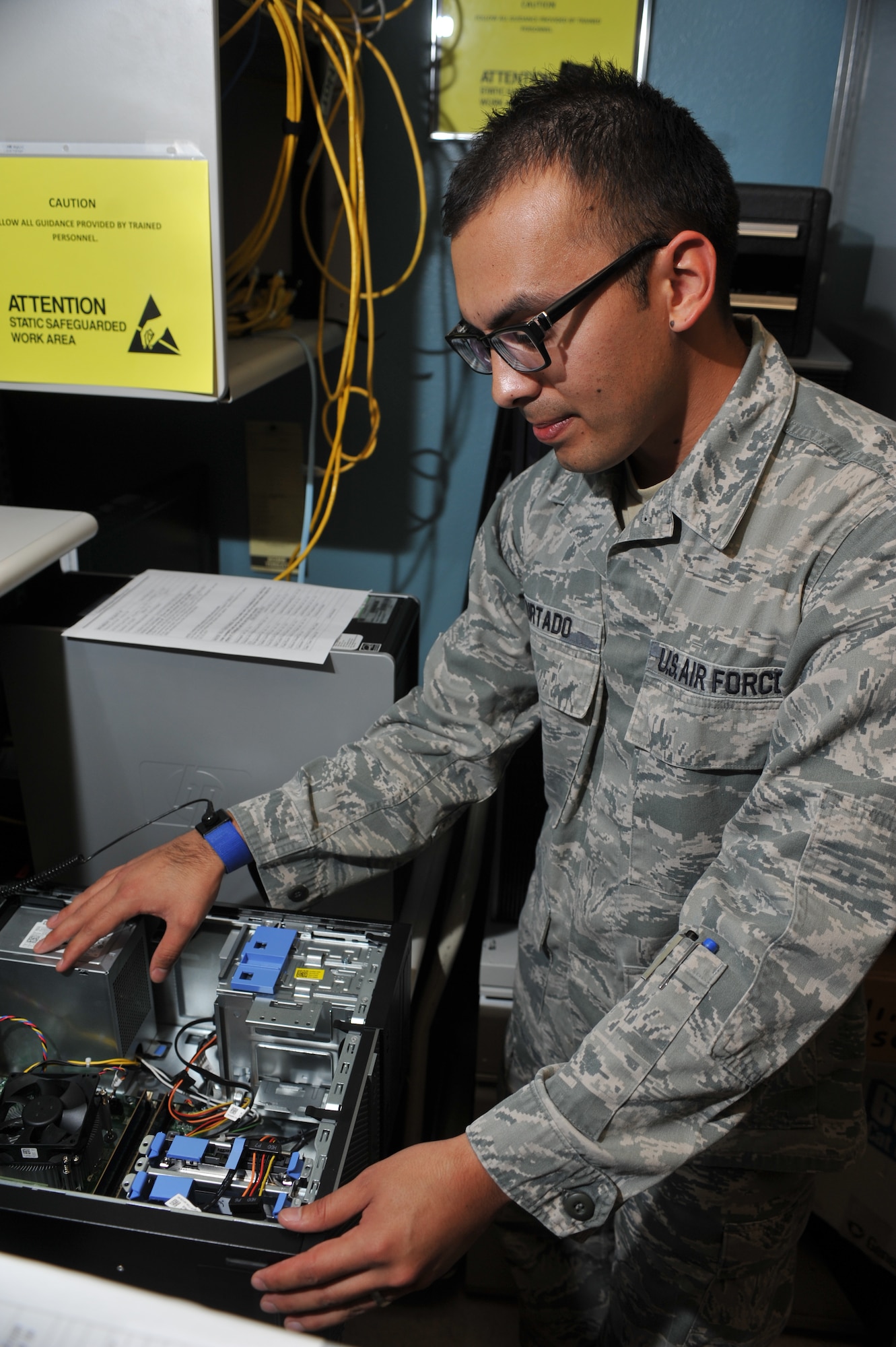 Staff Sgt. Miguel Hurtado, 56th Communications Squadron client systems technician, cleans the inside of a computer Feb. 18 at Luke Air Force Base. Hurtado is part of the comm focal point, helping to ensure the 5,000 clients on base are compliant with standards. (U.S. Air Force photo/Senior Airman Jason Colbert)