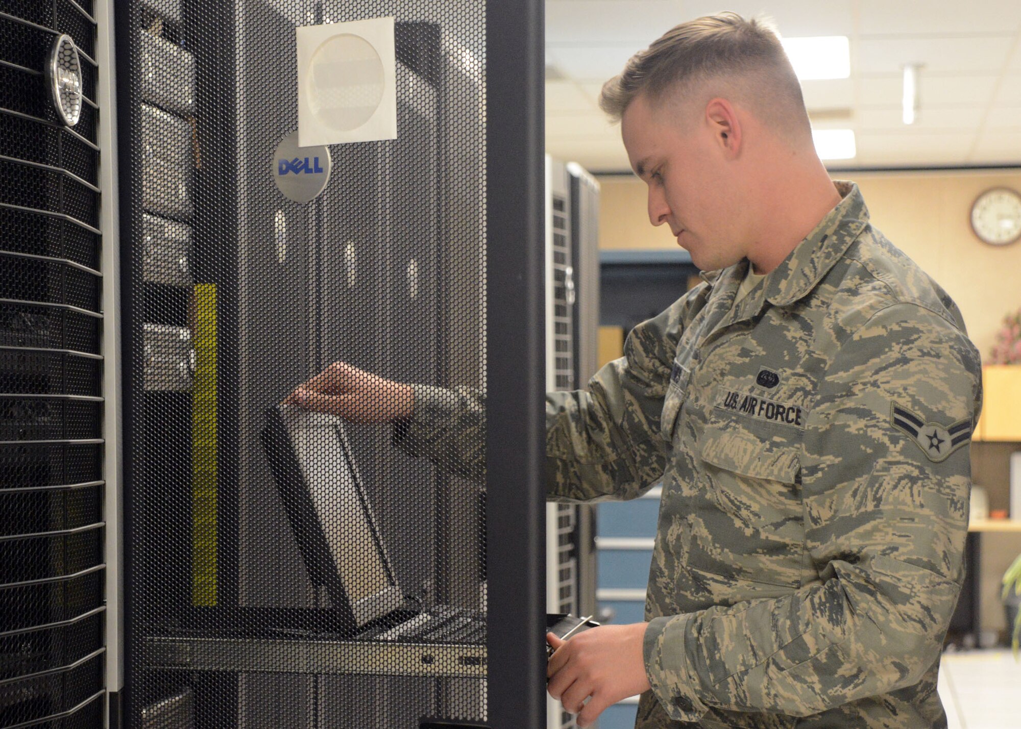 Airman 1st Class Jeremiah Barnes, 56th Communications Squadron network operations journeyman, checks a laptop Feb. 21 at Luke Air Force Base. Barnes was selected to perform in Tops in Blue, the Air Force’s premiere expeditionary entertainment unit. (U.S. Air Force photo/Senior Airman Devante Williams)