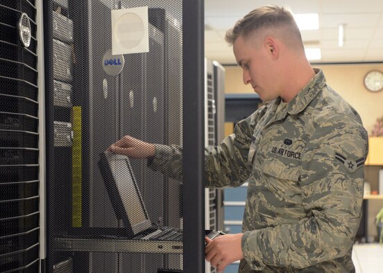 Airman 1st Class Jeremiah Barnes, 56th Communications Squadron network operations journeyman, checks a laptop Feb. 21 at Luke Air Force Base. Barnes was selected to perform in Tops in Blue, the Air Force’s premiere expeditionary entertainment unit. (U.S. Air Force photo/Senior Airman Devante Williams)
