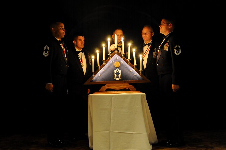 FROM LEFT: Chief Master Sgt. Barrington Bartlett, 56th Equipment Maintenance Squadron; Senior Master Sgt. David Corbett, 56th Civil Engineer Squadron; Senior Master Sgt. R. Dale Deskins, 56th Maintenance Group; Senior Master Sgt. Donald Stroud, 56th Aircraft Maintenance Squadron; and Senior Master Sgt. Rocky Thomas, 309th Aircraft Maintenance Unit, participated in the lighting ceremony Feb. 21 at the chief recognition ceremony at Luke Air Force Base. The nine candles represent each enlisted rank of the Air Force as well as the memories, hardships and responsibilities gained by those who attain chief master sergeant.  (U.S. Air Force photo/Airman 1st Class Pedro Mota)
