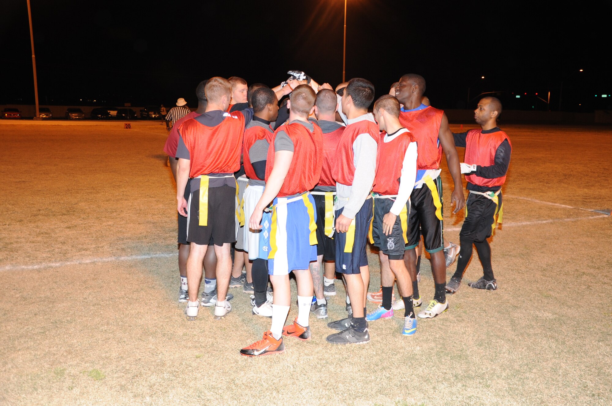 The 56th Security Forces Squadron team huddles Feb. 19 before the start of the second half of the 2014 intramural football season championship game at Luke Air Force Base. They beat the 56th Communications Squadron 19-18 in intramural play. (U.S. Air Force photo/Staff Sgt. Luther Mitchell Jr.)