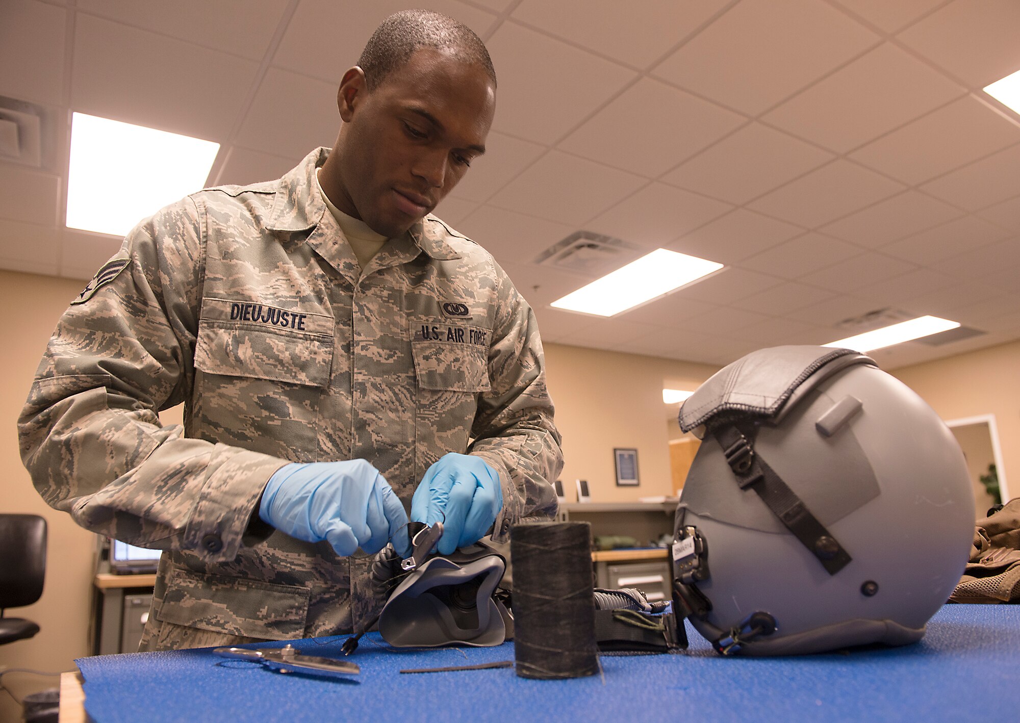 U.S. Air Force Senior Airman Dieri Dieujuste, 23d Operations Support Squadron aircrew flight equipment technician, maintains a combat edge oxygen mask at Moody Air Force Base, Ga., Feb. 27, 2014. AFE Airmen are responsible for maintaining masks, helmets, parachutes, night vision goggles, survival vests and many other items instrumental in the safety of the pilot’s life. (U.S. Air Force photo by Senior Airman Tiffany M. Grigg/Released) 