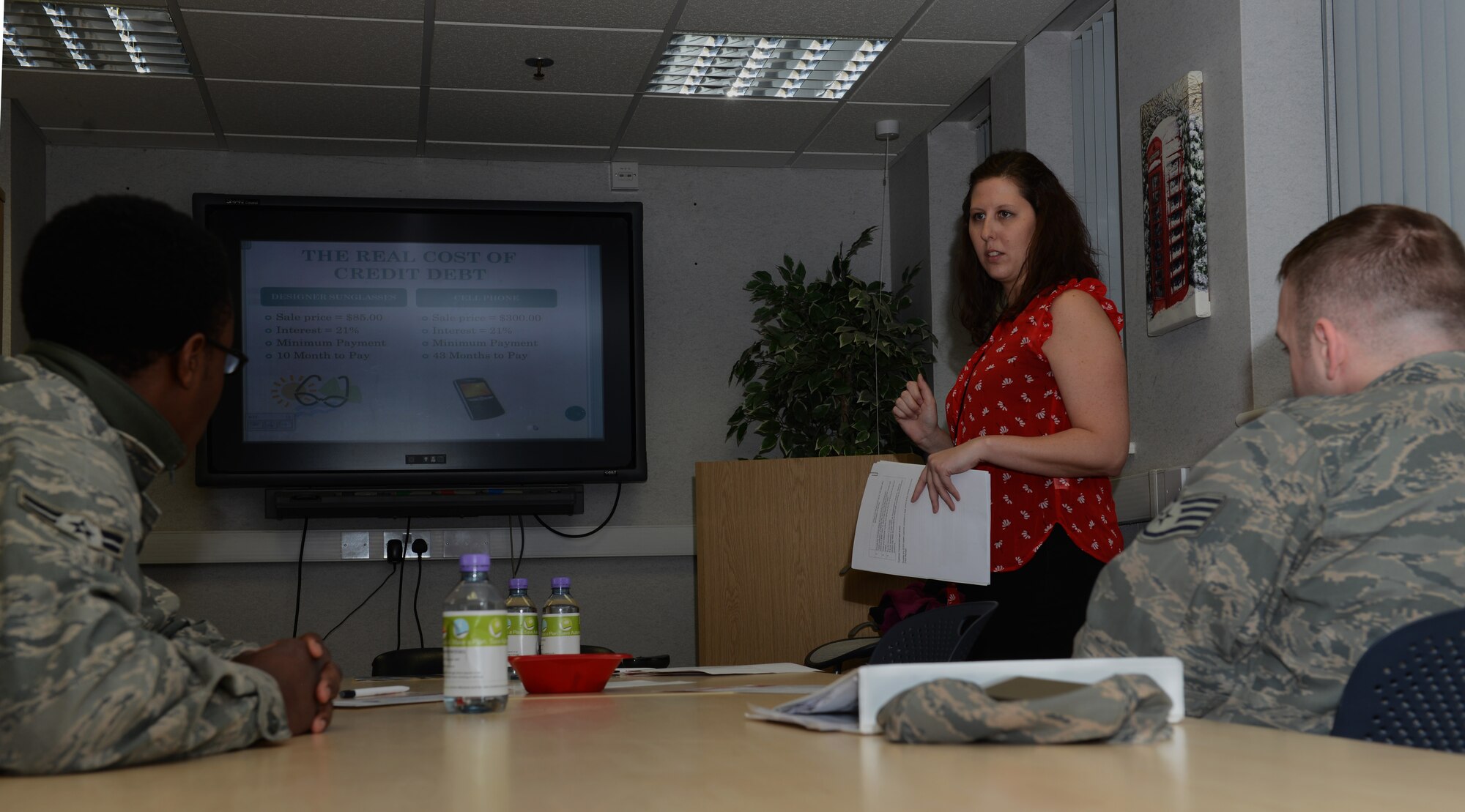 Hannah Nowak, customer service representative with an on-base bank, speaks to Team Mildenhall members about finances and credit Feb. 28, 2014, at the Airman and Family Readiness Center on RAF Mildenhall, England. The A&FRC coordinated with banks on base to provide financial readiness briefings as part of Military Saves Week. Topics covered included building budgets, wise credit card usage, achieving financial goals, retirement investments and an explanation of credit scores. (U.S. Air Force photo by Airman 1st Class Preston Webb/Released)
