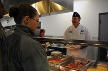 WRIGHT-PATTERSON AIR FORCE BASE, Ohio - Lt. Col. Mitchell Richardson, 89th Airlift Squadron commander, serves lunch to 445th Airlift Wing reservists at the Pitsenbarger Dining Facility here during the Feb. 9 unit training assembly. Commanders and first sergeants take time out throughout the year to serve Airmen at the dining hall to show their appreciation for their service. (U.S. Air Force photo/Tech. Sgt. Anthony Springer) 
