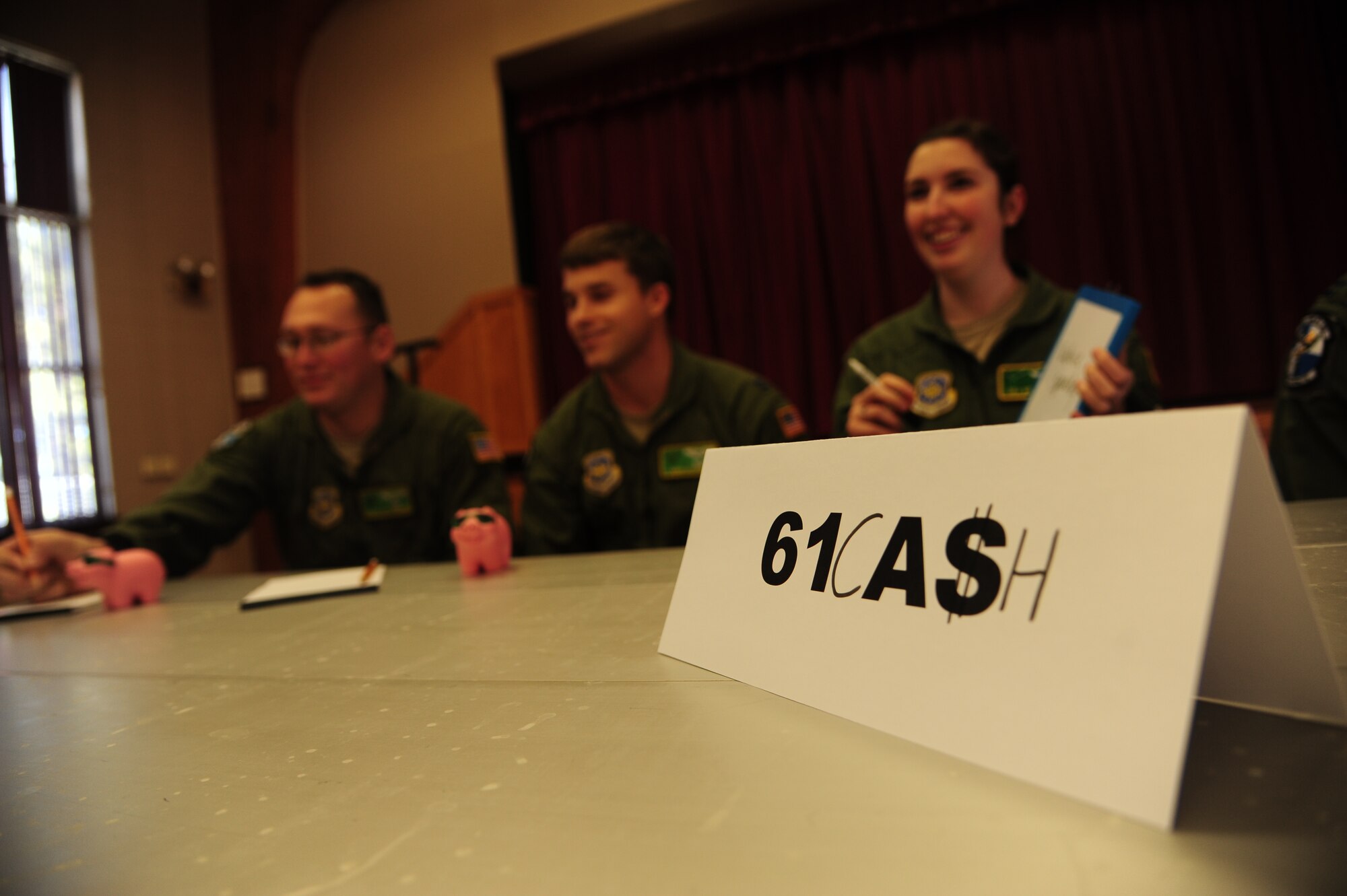 A team of Airmen from the 61st Airlift Squadron answers questions during Military Saves Week Feb. 25 at Little Rock Air Force Base. The goals for this year's campaign are to provide financial education to every squadron and to contact 100 percent of Team Little Rock personnel with at least 80 percent taking the pledge. (U.S. Air Force photo by Senior Airman Kaylee Clark)