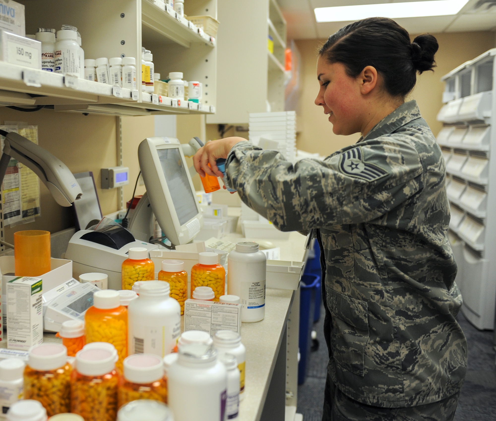 Staff Sgt. Natalia Currier, the 19th Medical Group noncommissioned officer in charge of the refill pharmacy, refills prescriptions called in by patients Feb. 24, 2014, at Little Rock Air Force Base, Ark. The refill pharmacy fills more than 300 prescriptions a day. (U.S. Air Force photo by Staff Sgt. Jessica Condit)