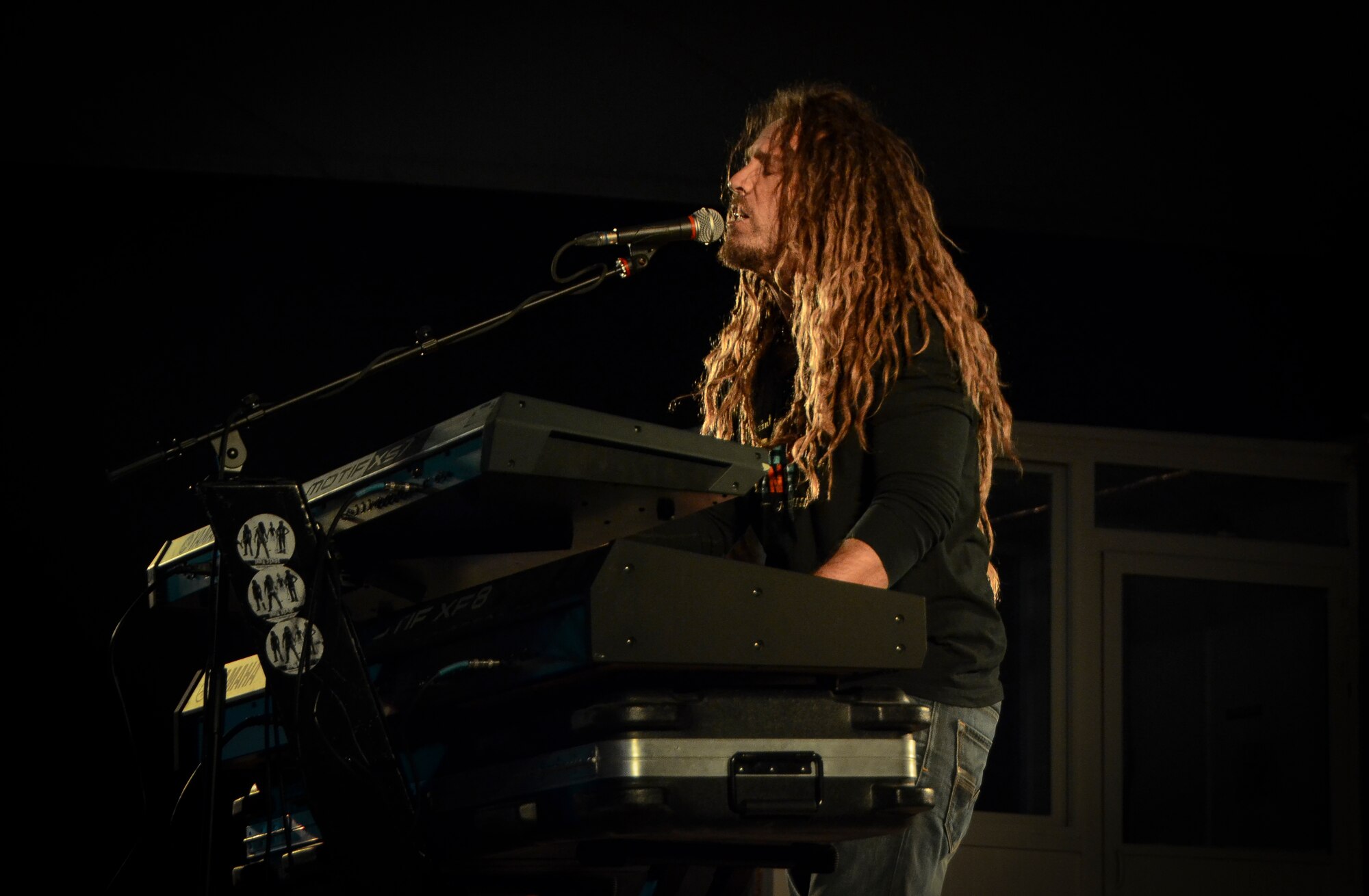 InnaSense’s lead singer Jimi Dred performs a reggae song for service members at Al Udeid Air Base, Qatar, Feb. 22, 2014. The reggae band which hails from Miami, Fla., played original songs and cover songs from various artist including Bob Marley, Dawn Penn and Shabba Rank. The band rendered a tribute to Bob Marley to celebrate his 69th birthday which was on Feb. 6, 2014. Army Capt. Maxine Reyes, deployed from Fort Jackson, S.C., and hails from Miami Beach, Fla., joined the band on stage to sing ‘No,no,no,’ ‘You don’t love me’ and ‘Mr. Loverman.’ InnaSense was invited to provide entertainment to the troops by the 379th Expeditionary Force Support Squadron.(U.S. Air Force photo/Senior Airman Jared Trimarchi) 