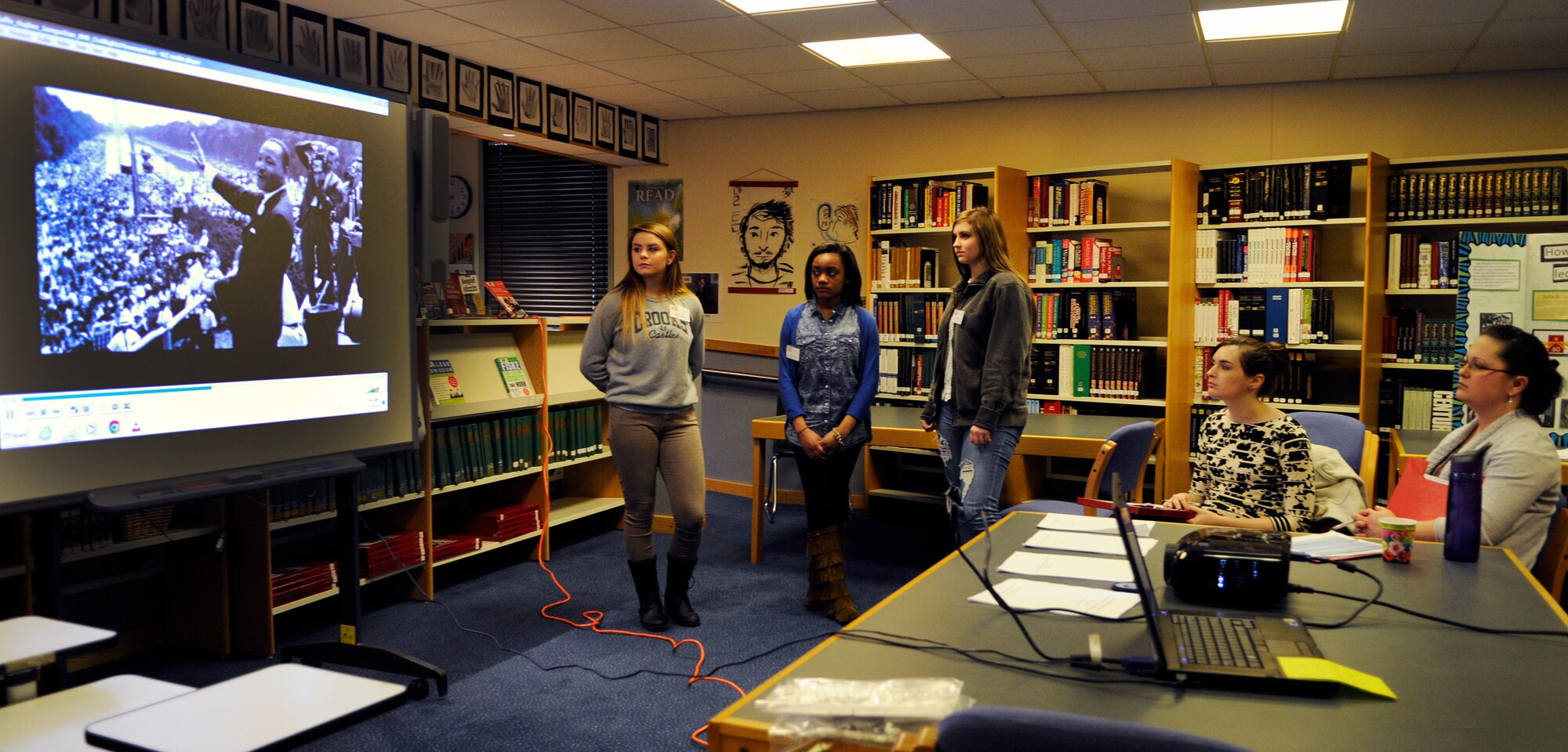 Brianna Jamgocian, (left) Shannettra Francis (center), and Brenna Hughes, give a presentation during the third annual National History Day school contest at Lakenheath High School on Royal Air Force Lakenheath, England, Feb. 27, 2014. Students worked individually, or in groups, to make projects such as exhibits, documentaries, research papers and websites based on this year's showcase theme, “rights and responsibilities”. (U.S. Air Force photo by Staff Sgt. Emerson Nuñez/Released)