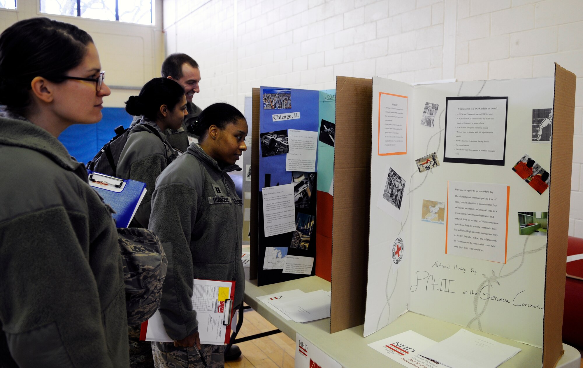 Judges examine two of 70 projects during the third annual National History contest at Lakenheath High School, on Royal Air Force Lakenheath, England, Feb. 27, 2014. There were a total of 125 students from six different schools participating in the contest. (U.S. Air Force photo by Staff Sgt. Emerson Nuñez/Released) 