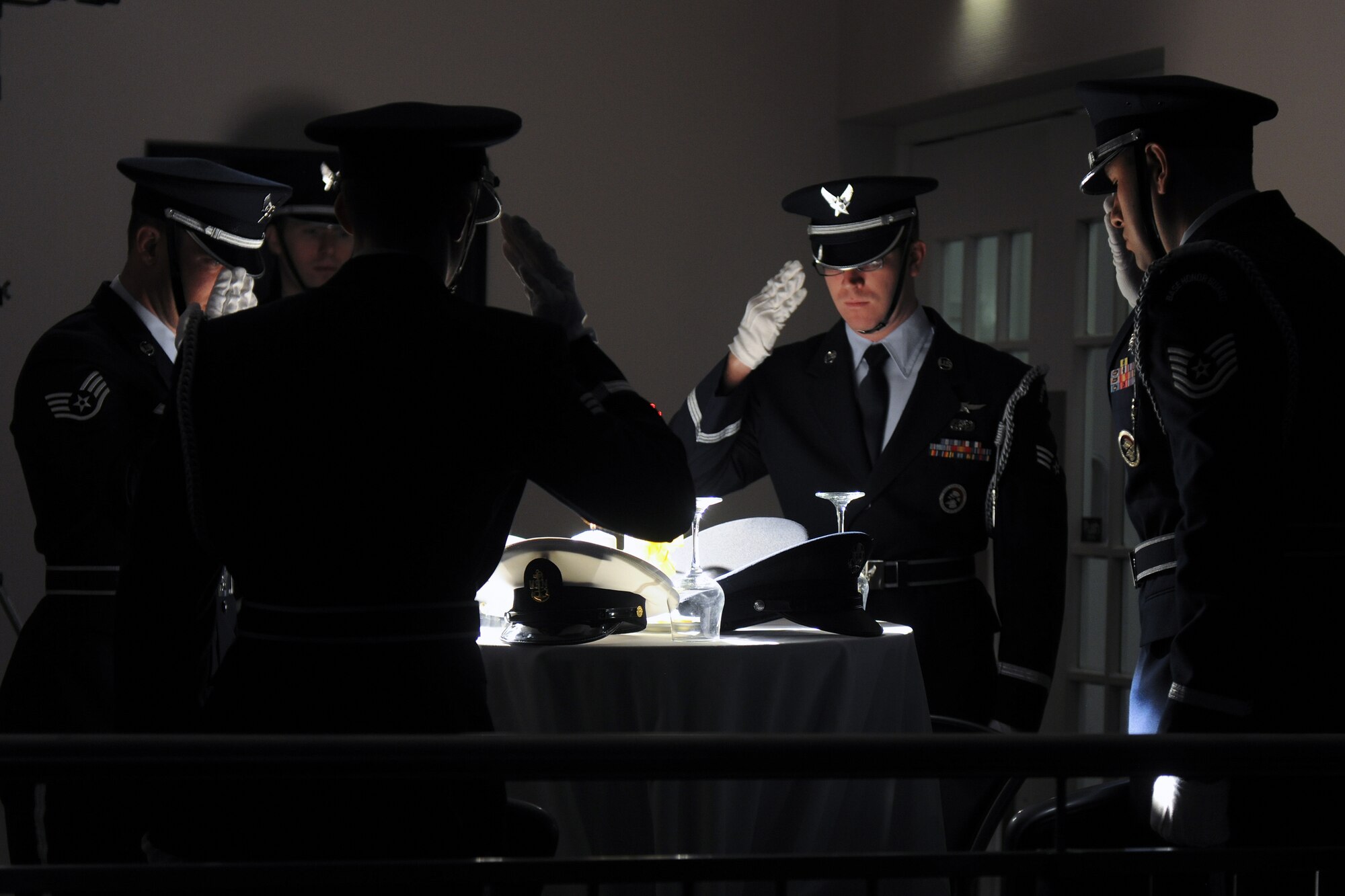 Airmen from the 422nd Air Base Group Honor Guard salute to honor Prisoners of War and Missing in Action at the start of the National Prayer Breakfast at RAF Croughton Feb. 13. The National Prayer Breakfast commemorated the 50th Anniversary of the Vientam War, and was a time to reflect on meaning of the war. (U.S. Air Force photo by Staff Sgt. Brian Stives)