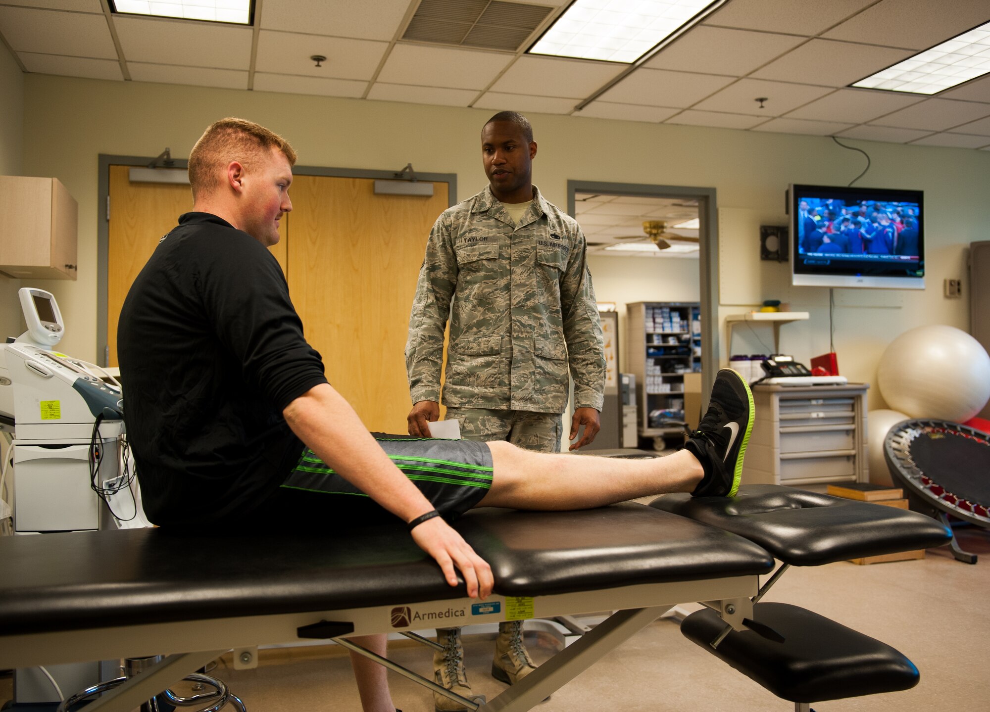 Tech. Sgt. Jeremiah Taylor, 8th Medical Operations Squadron physical therapy noncommissioned officer in charge, observes Airman 1st Class Tyler Beckle, 8th Security Forces Squadron, performing a stretch during a physical therapy session at Kunsan Air Base, Republic of Korea, Feb. 27, 2014.Physical therapy Airmen are available to help Wolf Pack Airmen stay physically and mentally resilient. (U.S. Air Force photo by Staff Sgt. Clayton Lenhardt/Released)