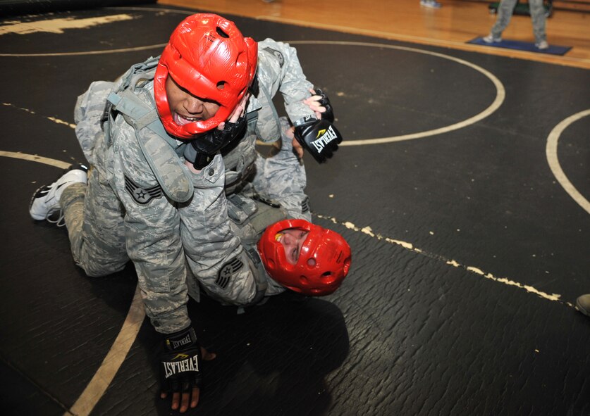 Airmen from the 51st Security Forces Squadron engage in combatives training during a House of Pain exercise in the fitness center at Osan Air Base, Republic of Korea, Feb. 27, 2104. Other events in the confidence course included sprints, box jumps and “Spiderman” push-ups, each lasting for 90 seconds. (U.S. Air Force photo/Airman 1st Class Ashley J. Thum)