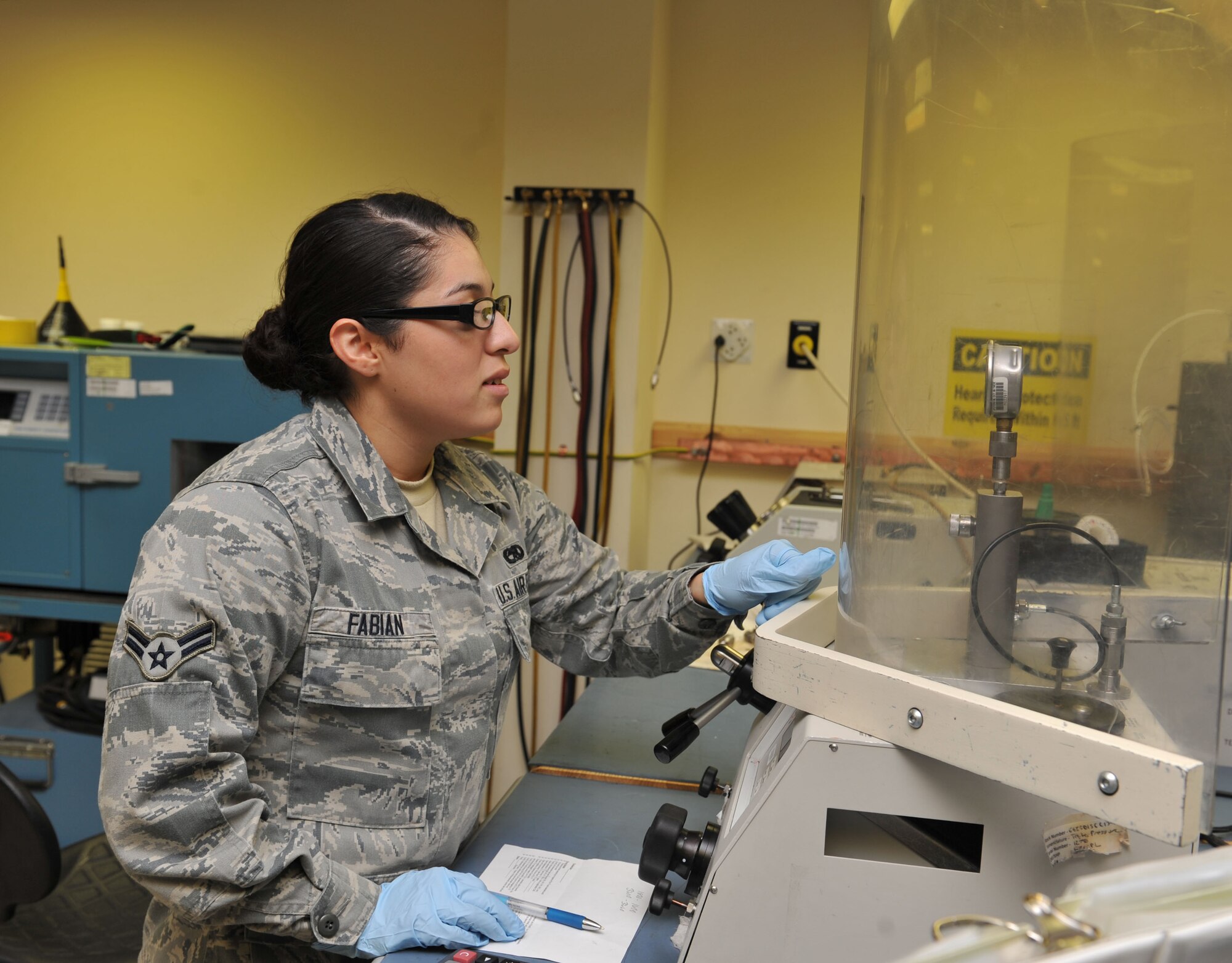 Airman 1st Class Erika Fabian calibrates a hydraulic pressure gauge at the 379th Expeditionary Maintenance Squadron Precision Measurement Equipment Laboratory, Al Udeid Air Base, Qatar, Feb. 25, 2014. Hydraulic pressure gauges are used for a variety of applications to include monitoring aircraft systems, check struts on landing gear, and give readings for the aircraft arresting emergency procedures. They are also used for various test stations that check brakes,  props, and engines. Fabian is a 379th EMXS PMEL technician deployed from Ramstein Air Base, Germany, and a Dinuba, Calif., native. (U.S. Air Force photo by Master Sgt. David Miller)