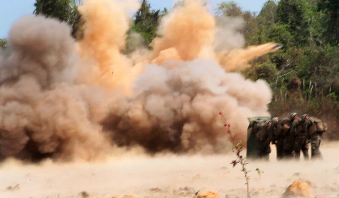 U.S. Marines shield themselves from the blast of a breaching charge explosion during Exercise Cobra Gold 2014 in Ban Chan Krem, Thailand, Feb. 14, 2014. 
