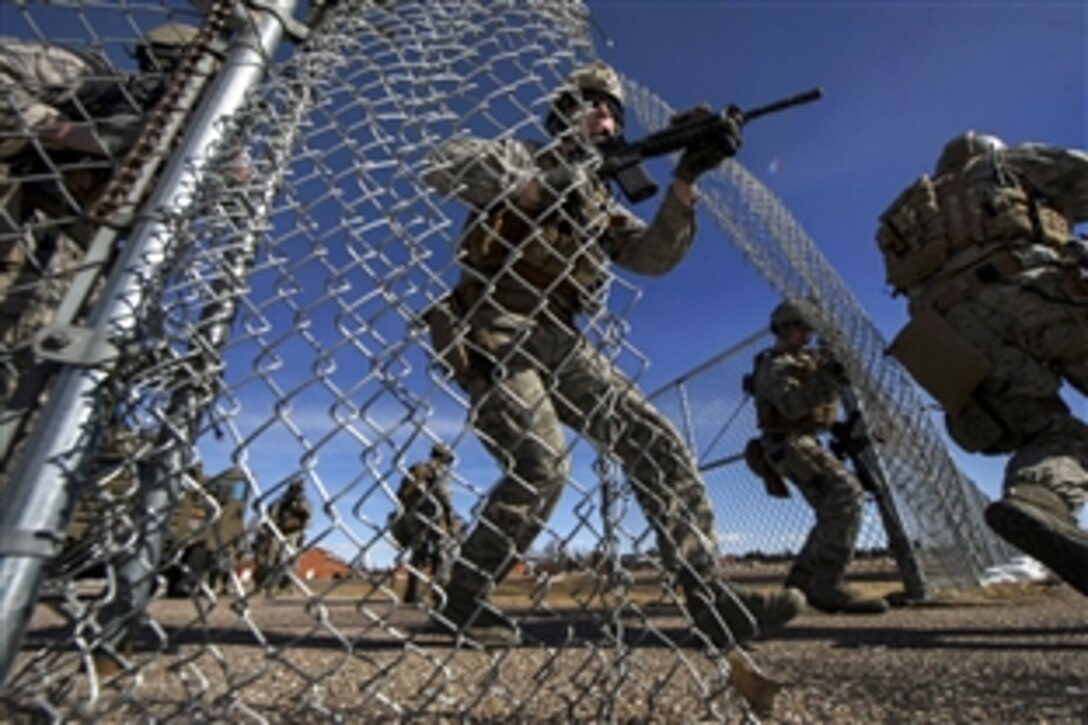 Air Force Staff Sgt. Glen Brott, center, moves toward a breached personnel access hatch during a launch facility re-capture exercise on F.E. Warren Air Force Base, Wyo., Feb. 18, 2014. Brott is assigned to the 90th Security Forces Group Tactical Response Force. 