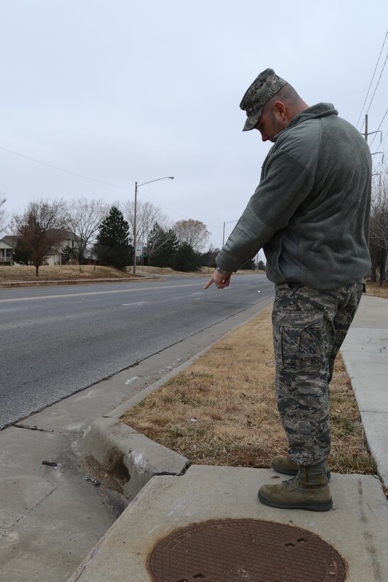 Tech. Sgt. Michael Morin, 22nd Aircraft Maintenance Squadron, points out an area where debris from a motorcycle landed after a crash in Wichita, Kan, Dec. 16, 2013. Morin and three other McConnell Airmen acted as first responders to a crash that resulted in one death, and injuries to two others. (U.S. Air Force photo/Senior Airman Trevor Rhynes)