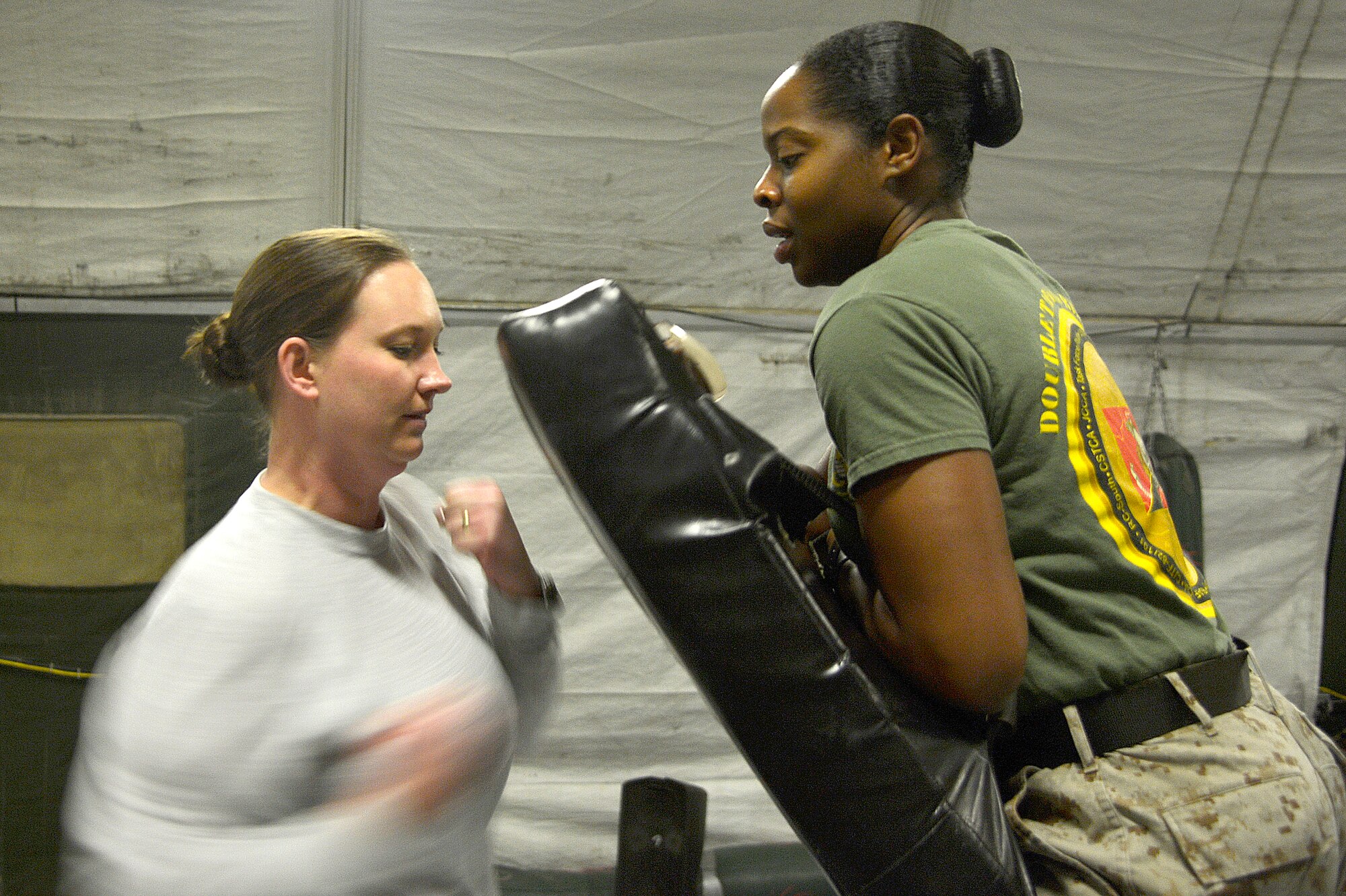 U.S. Air Force Capt. Jamie Woodson, 455th Expeditionary Medical Group primary care physician’s assistant, performs a right uppercut during the women’s self-defense class at Bagram Airfield, Afghanistan, Dec. 29, 2013. The class is held every Sunday from 3-5 p.m., and features techniques used in U.S. Marine Corps mixed martial arts. Woodson is deployed from Elmendorf Air Force Base, Alaska, and is a native of Florida. (U.S. Air Force photo by Senior Airman Kayla Newman/Released)