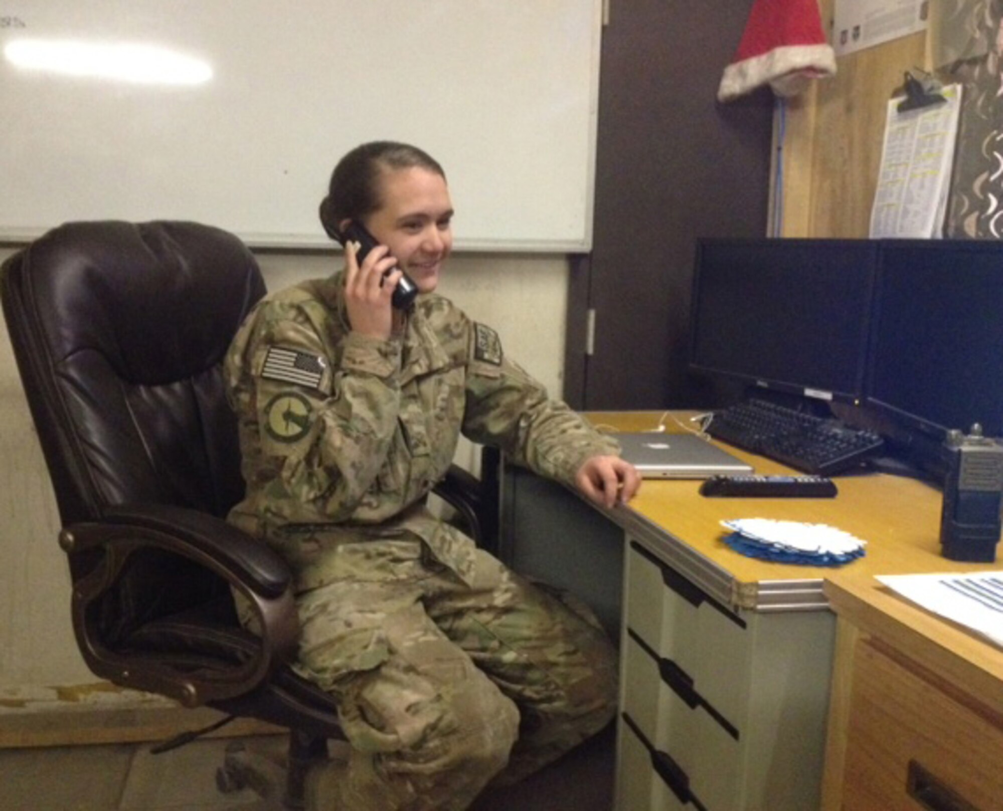Airman 1st Class Ashli Six receives a phone call from Secretary of the Air Force Deborah Lee James, Dec. 31, 2013 at Bagram Airfield, Afghanistan. The secretary called to wish deployed Airmen a happy new year and let them know the Air Force leadership team was thinking about them and their families. Six is a native of Green, Ohio. (Courtesy Photo)