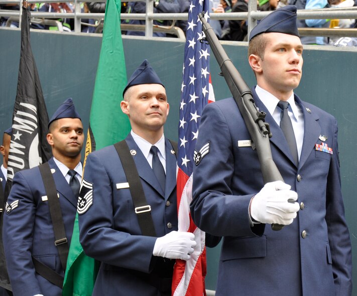 Senior Airman Matt Vanourek (front), 728th Airlift Squadron, Senior Master Sgt. Marvin Hitt, 446th Aircraft Maintenance Squadron (middle), and Senior Airman Benjamin Taylor, 62nd Aircraft Maintenance Squadron, line up for their color guard detail portion of the pregame ceremonies for the Seattle Seahawks home game at Century Link Field in Seattle, Wash., Dec. 29.  More than 40 active-duty, Reserve and Guard Airmen volunteered to represent and honor the U.S. Air Force during this game.  (U.S. Air Force photo by 1st Lt. Lori Fiorello)