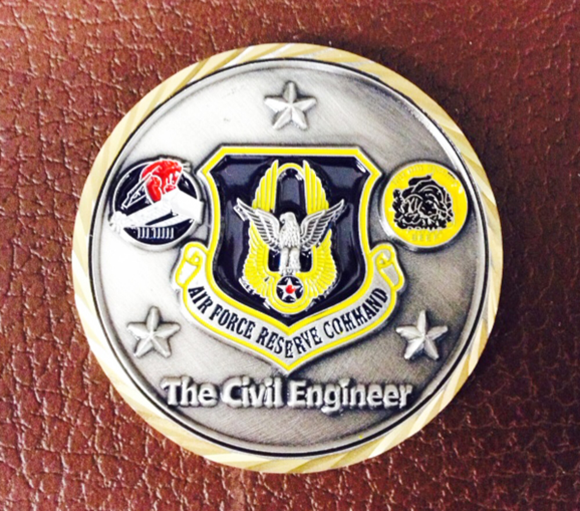 Chad Hypes and Kristen Gordon, 94th Civil Engineering Squadron project engineers, were coined by Col. Roy Alan Agustin, Air Force Reserve Command civil engineer Nov.19 for their outstanding work on several key projects for the 94th Airlift Wing. (Courtesy photo)