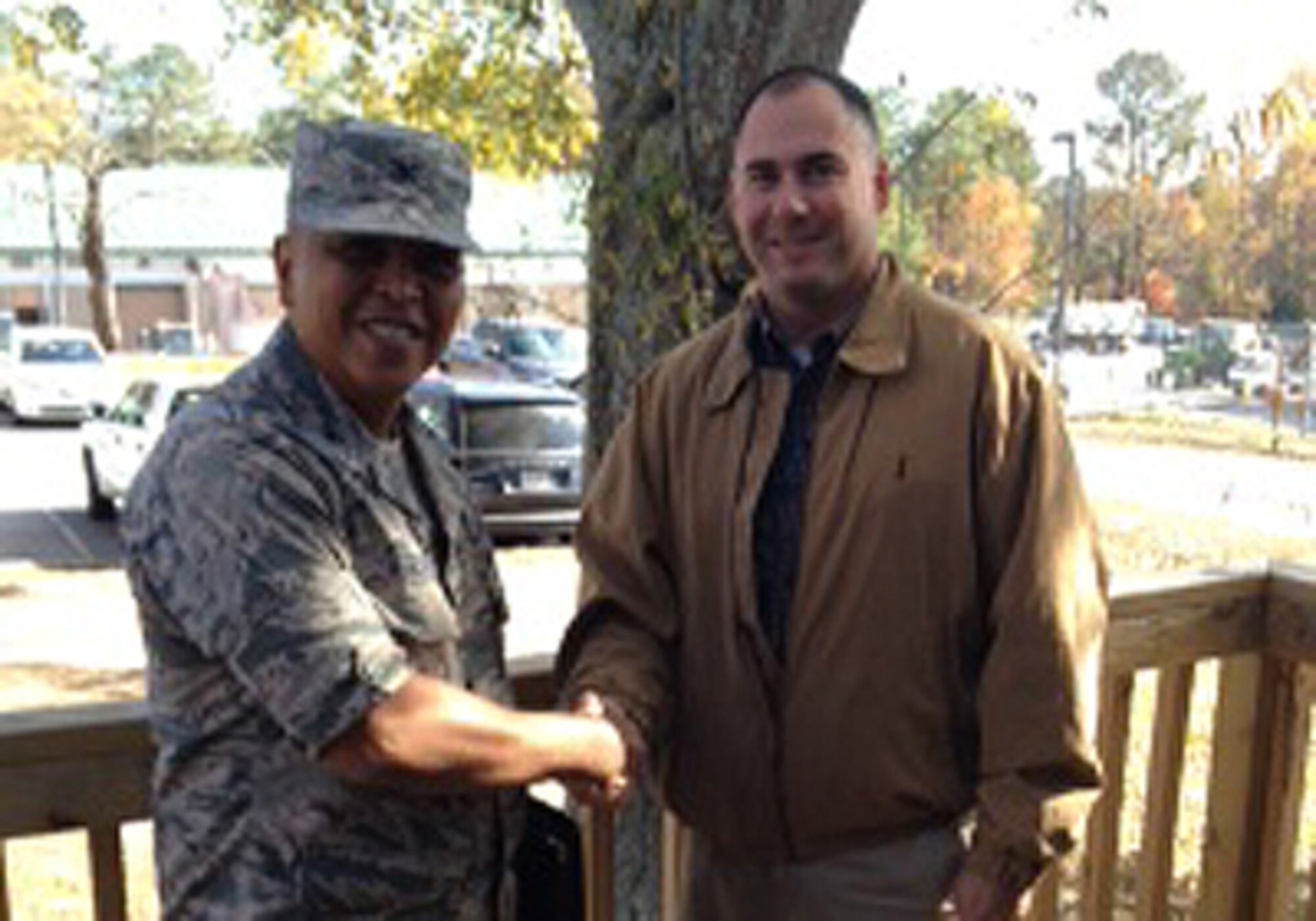 Chad Hypes, 94th Civil Engineering Squadron project engineer, is coined byCol. Roy Alan Agustin, Air Force Reserve Command civil engineer Nov.19 for outstanding work on several key projects for the 94th Airlift Wing. (Courtesy photo)