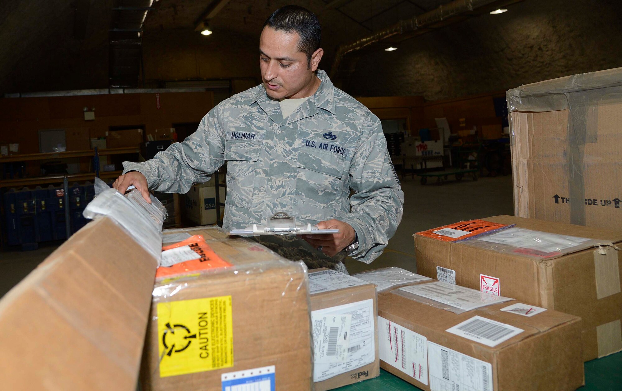 Master Sgt. Josue Molinar, 386th Expeditionary Logistics Readiness Squadron, “in-checks” cargo during an unload, undisclosed location, Southwest Asia. Molinar is the chief of cargo for the travel management office, deployed from Joint Base Elmendorf-Richardson, Alaska and is a native of El Paso, Texas.