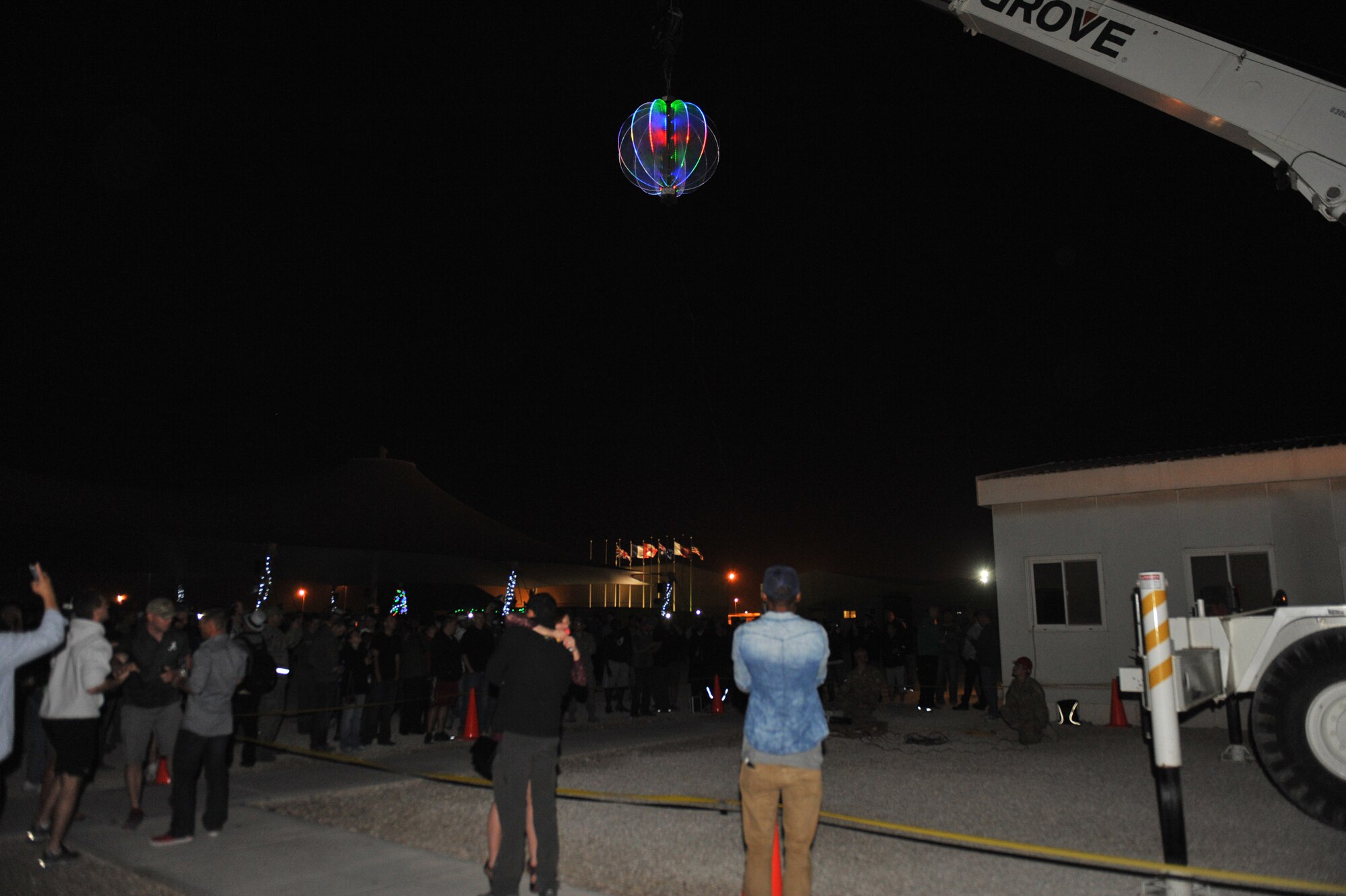 Service members celebrate the New Year by the raising of the ball at the 379th Air Expeditionary Wing, Southwest Asia, Dec. 31, 2013. DJ Babey Drew, The Farm, a country music band that merges different genres into a unique sound and comedienne Iliza Shlesinger, winner of NBC's Last Comic Standing competition performed for deployed service members and helped ring in 2014. (U.S. Air Force photo by Master Sgt. David Miller)