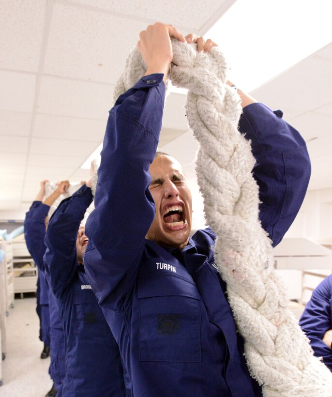 U.S. Coast Guard Seaman Recruit Tyler Turpin conducts remedial line handling at Training Center Cape May, N.J., Dec. 31, 2013. The recruits must press the 150-pound towing hawser over their heads while reciting the Coast Guard's core values of honor, respect and devotion to duty. 