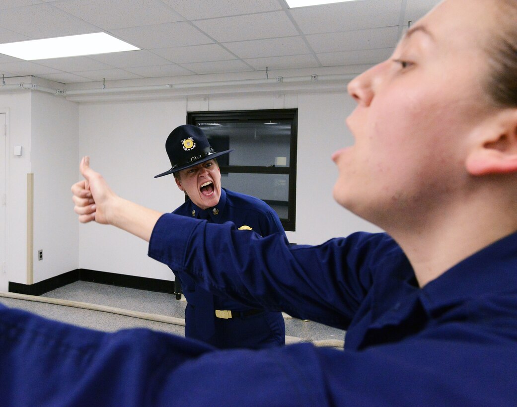 U.S. Coast Guard Petty Officer 1st Class Tanya LaFrance motivates a recruit during incentive training in James Hall at Training Center Cape May, N.J., Dec. 31, 2013. 