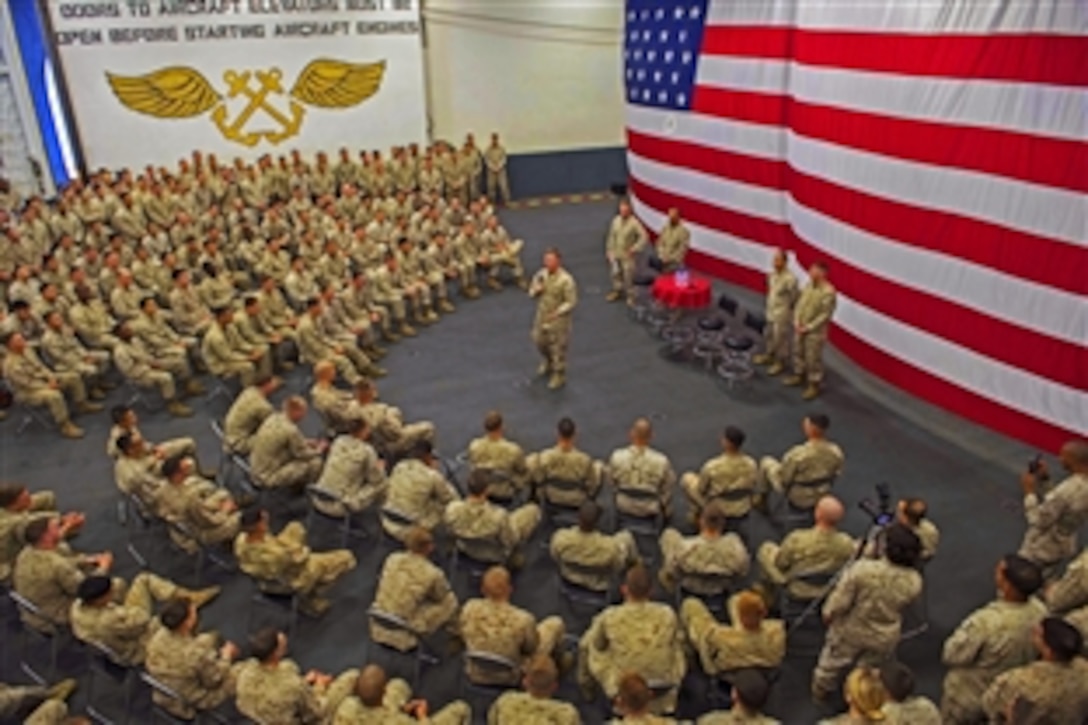 Dakota L. Meyer, a Medal of Honor recipient now serving as a U.S. Marine Corps sergeant in the reserves addresses U.S. sailors and Marines in the hangar bay aboard the USS Boxer in the Arabian Gulf, Dec. 27, 2013. The Boxer is the flagship for the Boxer Amphibious Ready Group and, with the embarked 13th Marine Expeditionary Unit, is deployed in support of maritime security operations and theater security cooperation efforts in the U.S. 5th Fleet area of responsibility.