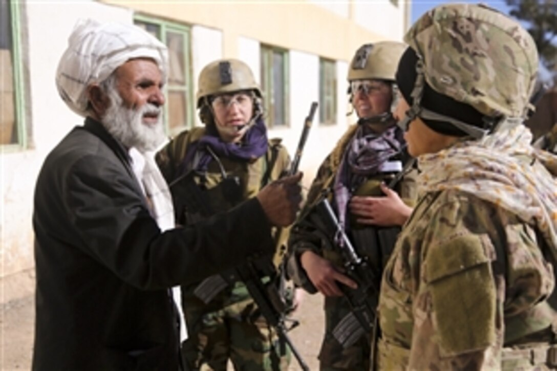 Members of the Afghan army’s 4th Special Operations Kandak and a U.S. Army cultural support team visit a village in Shindand district, Herat province, Afghanistan, to deliver school supplies to an all-female school and provide humanitarian aid, Dec. 28, 2013. 