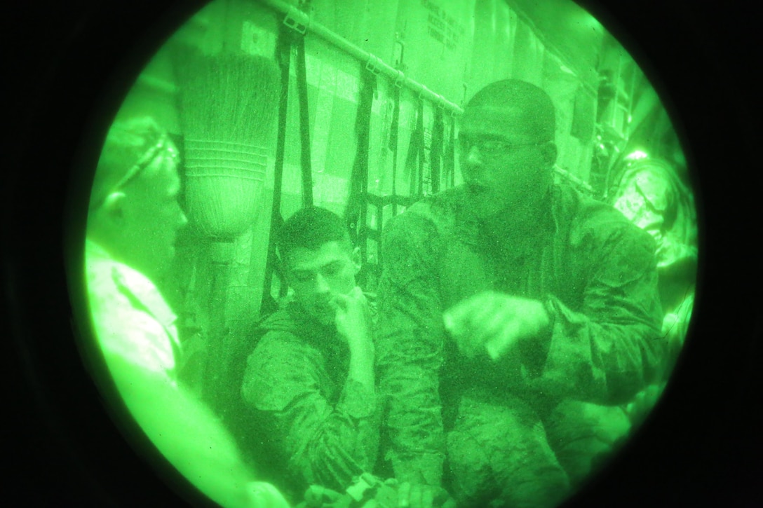 Cpl. Alexander M. Mayberry, a team leader with Special-Purpose Marine Air-Ground Task Force, briefs his team in a KC-130J Hercules cargo plane on their way from Camp Lemonnier, Djibouti to Entebbe, Uganda, to support potential operations in South Sudan, Dec. 24, 2013.  The Marines and Sailors of SP-MAGTF CR are currently postured in both Djibouti and Uganda in order to better respond to threats against U.S. personnel and interests in South Sudan.  SP-MAGTF Crisis Response is a self-mobile, self-sustaining force capable of responding to a range of crises to protect both U.S. and partner-nation security interests in the region, while also strengthening partnerships throughout the U.S. European Command and U.S. Africa Command area of responsibility. 