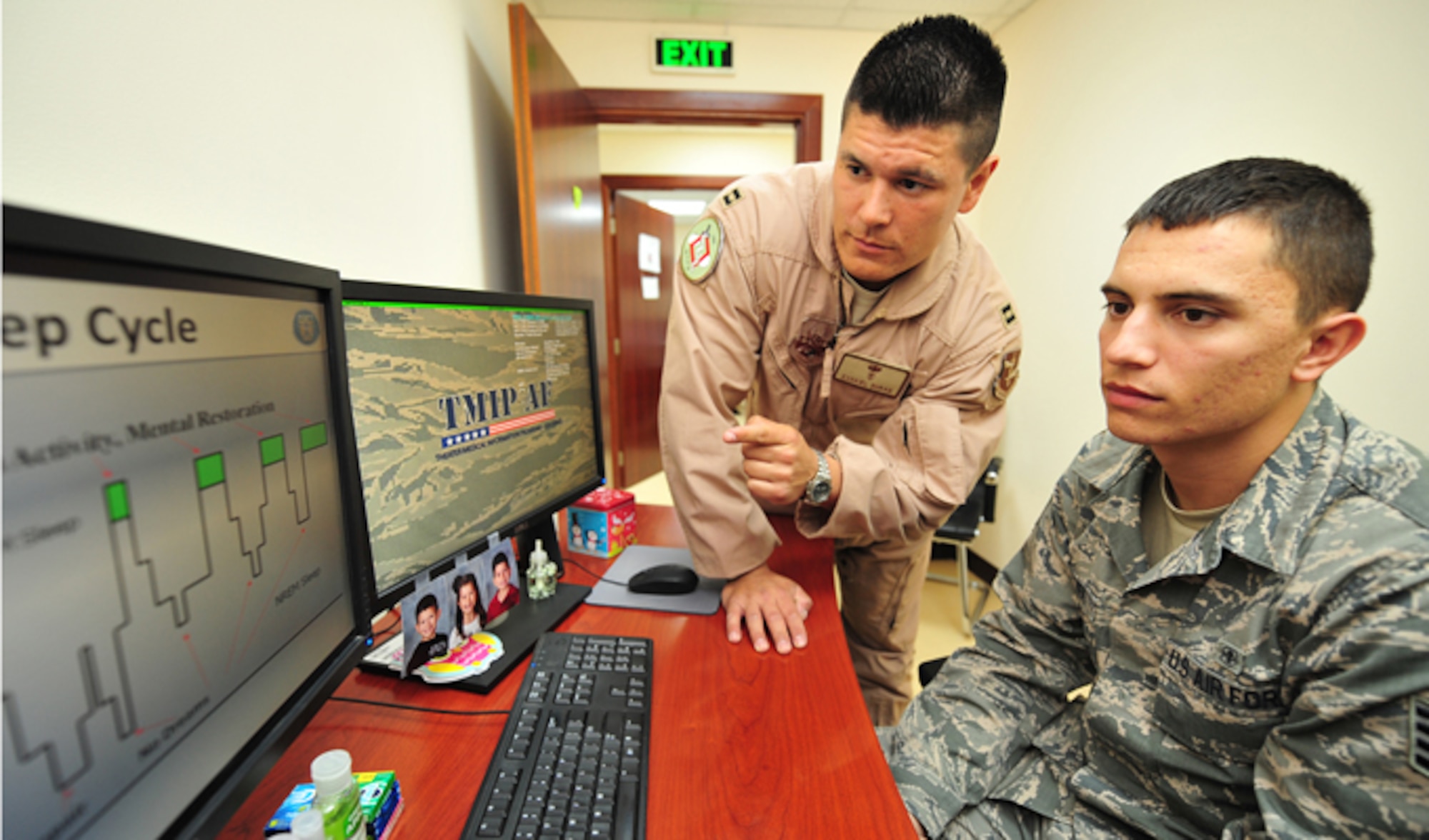 Capt. Ezekiel "E.Z." Duran discusses a sleep cycle with Staff Sgt. Randall Kinchen Jan. 1, 2014 at the 380th Air Expeditionaryt Wing in Southwest Asia. Duran’s duties as a physiologist include improving warfighter performance and safety by increasing awareness and understanding of human factor challenges, while mitigating or eliminating human errors and mishaps. Duran is a physiologist with the 380th Expeditionary Medical Group and Kinchen is 380th EMDG unit deployment manager. (U.S. Air Force photo/Staff Sgt. Michael Means)