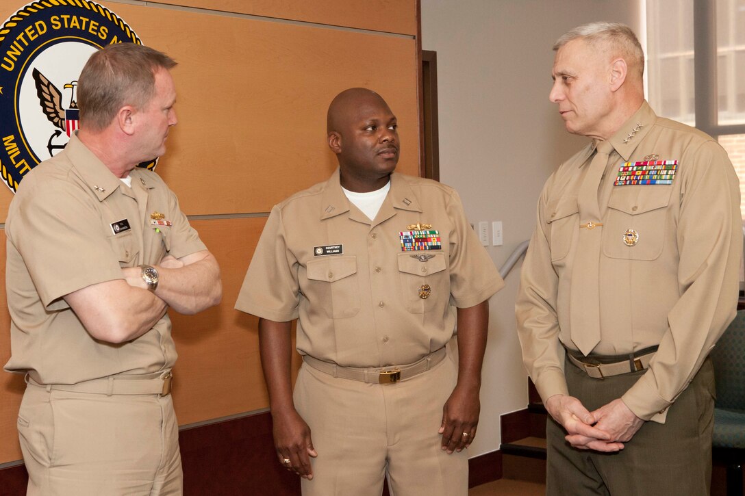From the left, Rear Adm. T. K. Shannon; Lt. Courtney Williams; and the Assistant Commandant of the Marine Corps, Gen. John M. Paxton, Jr., speak with one another after Williams promotion ceremony at the Washington Navy Yard in Washington, D.C., Jan. 3, 2014. (U.S. Marine Corps photo by Cpl. Tia Dufour/Released)