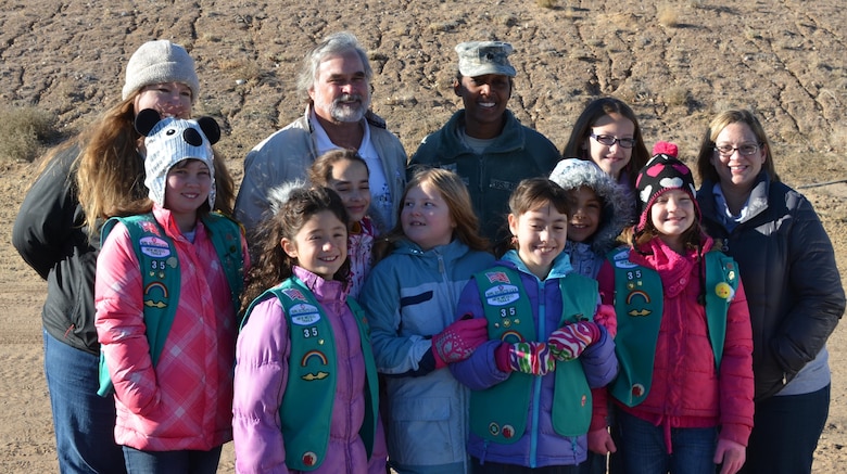 ALBUQUERQUE, N.M., -- Kurt Wagener, field engineer for the Albuquerque Metropolitan Arroyo Flood Control Authority, back row second from left; Lt. Col. Antoinette Gant, commander, US Army Corps of Engineers, Albuquerque District; and Girl Scout Troop #35, New Mexico, pose for a photo, Dec. 14, 2013, at the Calabacillas Arroyo prior to working on the owl habitat.