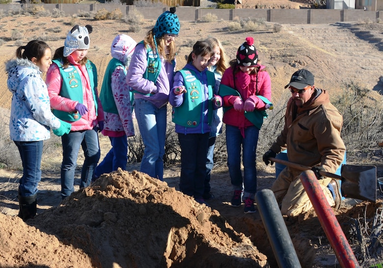 ALBUQUERQUE, N.M., -- The scouts get ready to assist contractor Korry Tillbury, Mountain West GolfScapes, as he prepares to place a 55-gallon drum in the ground as part of the new burrowing owl habitat, Dec. 14, 2013.  