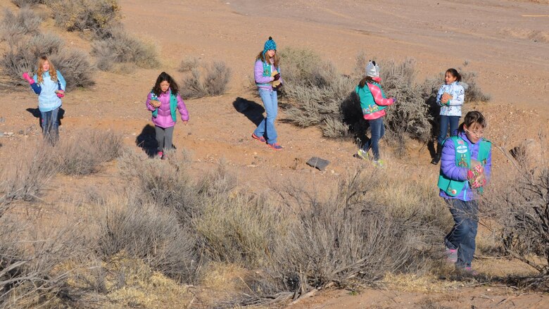 ALBUQUERQUE, N.M., -- The scouts gather large rocks, Dec. 14, 2013, to place in front of the new owl habitats in order to prevent predators from entering the owl habitats.